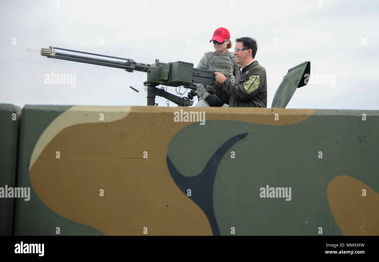 The Honorable Scott Walker, Governor of Wisconsin, fires blanks rounds from a .50 caliber machine gun mounted on a HMMWV during an 8th Security Forces Squadron demonstration at Kunsan Air Base, Republic of Korea, Sept. 16, 2017. Walker visited Wisconsin Air National Guard 115th Fighter Wing Airmen deployed as part of a Theater Security Package and gained a greater understanding of the Wolf Pack’s mission. (U.S. Air Force photo by Senior Airman Colby L. Hardin) Stock Photo