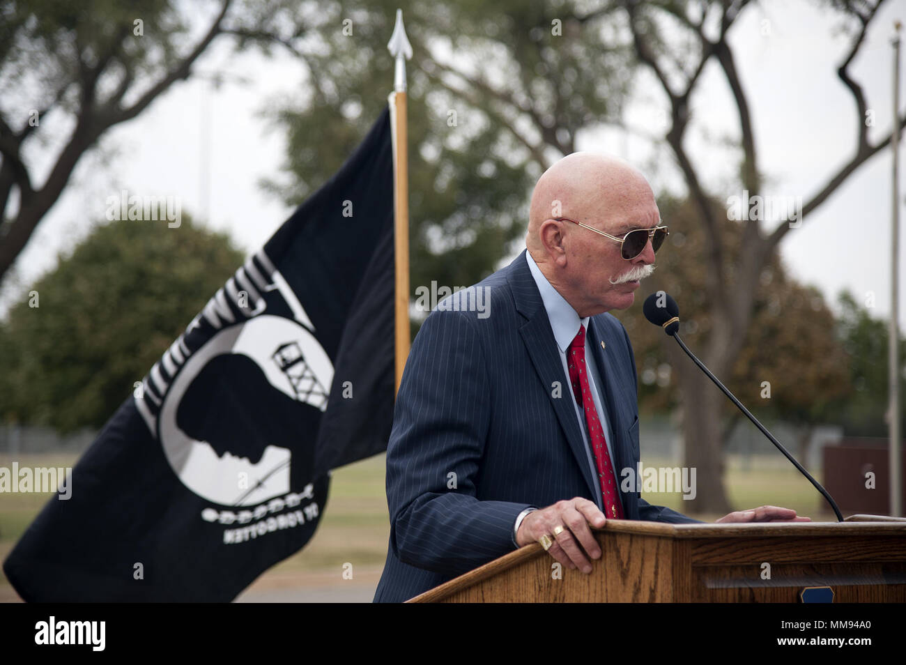 Lt. Col. Retired William R. Schwertfeger speaks at a POW/MIA ceremony on Sept. 9, 2017 at the Vance Air Force Base flagpole. Schwertfeger, an F-4 pilot during the Vietnam war, was held as a prisoner of war in 1972 for 407 days in the “Hanoi Hilton” prison in Vietnam. (U.S. Air Force Photo by Airman Zachary Heal) Stock Photo