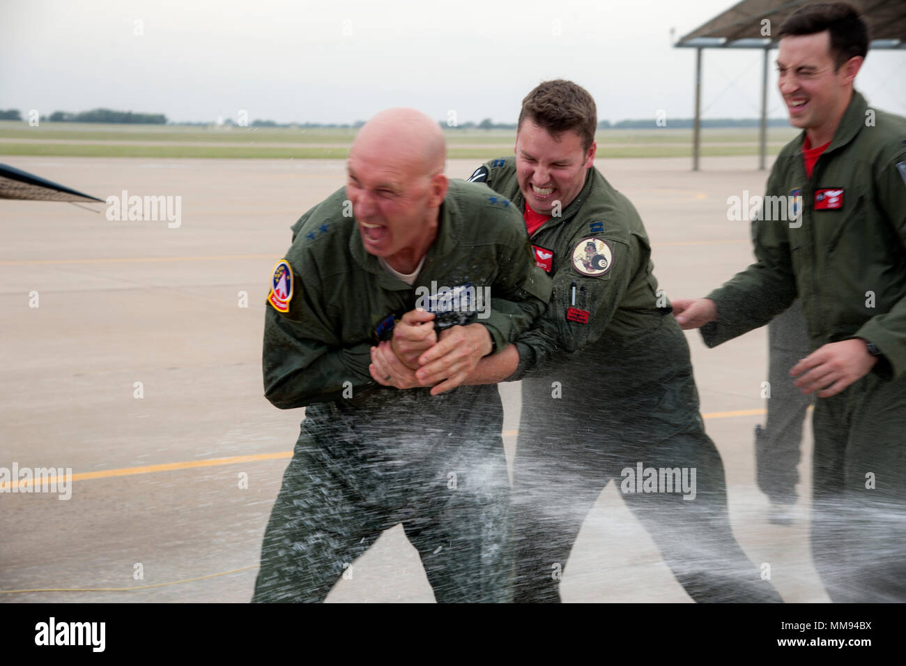 Maj. Gen. Timothy M. Zadalis, the U.S. Air Forces in Europe and Air Forces Africa vice commander, attempts to evade being sprayed with water following his “fini” flight Sept. 15, 2017 at Vance Air Force Base Okla. It is tradition, following a “fini” flight, to spray the pilot with water after they exit the aircraft. Zadalis is a graduate of Vance Undergraduate Pilot Training Class 85-04. (U.S. Air Force photo by Airman Zachary Heal) Stock Photo