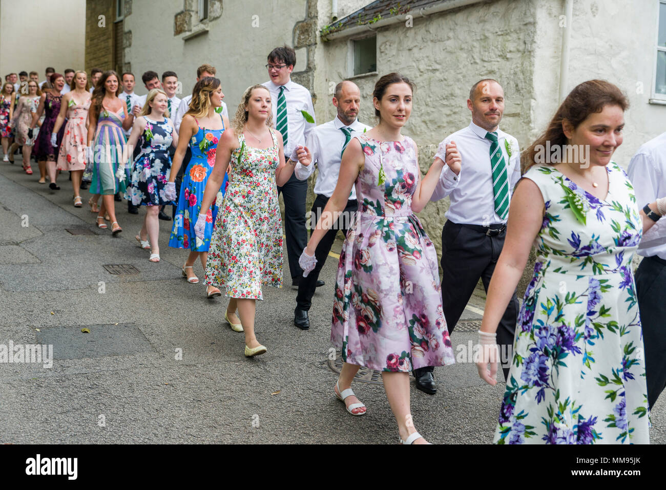 Editorial: Unknown members of the public, potential logo and other trademarks. Helston, Cornwall, UK, 08/05/2018. Dancers make their way through the s Stock Photo