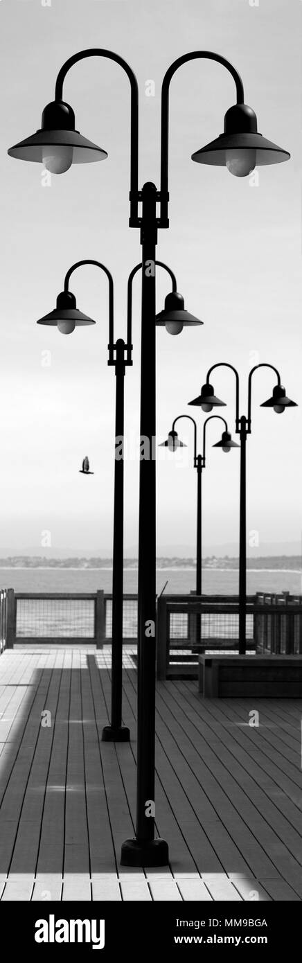 Decorative light fixtures line the famous Cannery Row harbor. Stock Photo