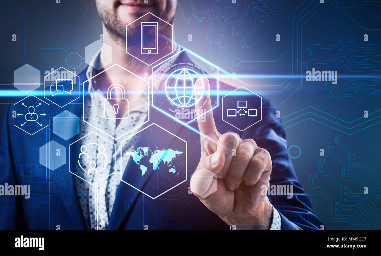 Businessman pressing on virtual icons in cyberspace. Stock Photo