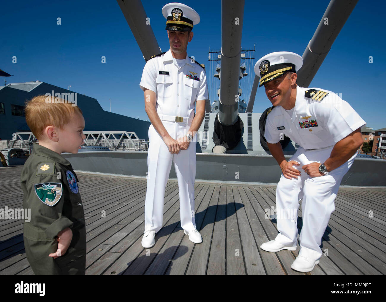 170908-N-GR120-054  NORFOLK (Sept. 8, 2017) Cmdr. Jason Sherman, right, assigned to the Nimitz-class aircraft carrier USS George Washington (CVN 73) Lt. Joey Zerra's, son before promoting Zerra to Lt. Cmdr. during a ceremony aboard the Iowa-class battleship USS Wisconsin (BB-64). George Washington is undergoing a refueling and complex overhaul (RCOH) at Newport News Shipyard. RCOH is a four-year project performed only once during a carrier’s 50-year service life that includes refueling of the ship’s two nuclear reactors, significant repairs, upgrades and modernizations. (U.S. Navy photo by Mas Stock Photo