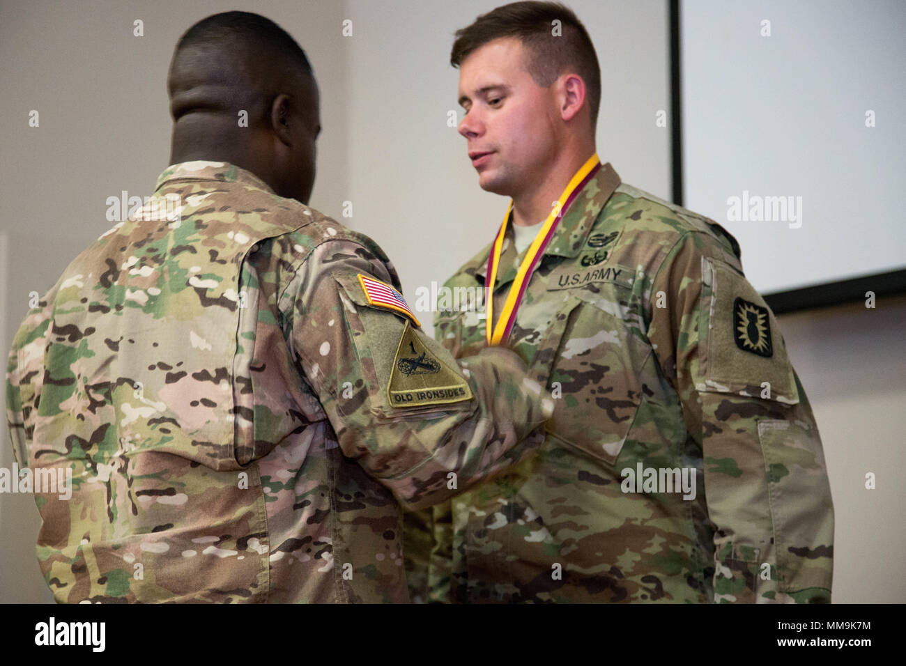 U.S. Army Brig. Gen. David Wilson, the 40th Chief of the Ordnance and Commandant of the United States Army Ordnance School, awards Spc. William Helms with first place medal during the closing ceremony for the Explosive Ordnance Disposal (EOD) Team of the Year at Fort A.P. Hill, Va., Sept. 15, 2017. The U.S. Army Ordnance Crucible is a three-part competition, comprised of the Ammunition Transfer Holding Point, Combat Repair Team, and now on their final course the Explosive Ordnance Disposal, which is designed to get Soldiers' teamwork and critical thinking skills.  (U.S. Army photo by Pfc. Kyar Stock Photo