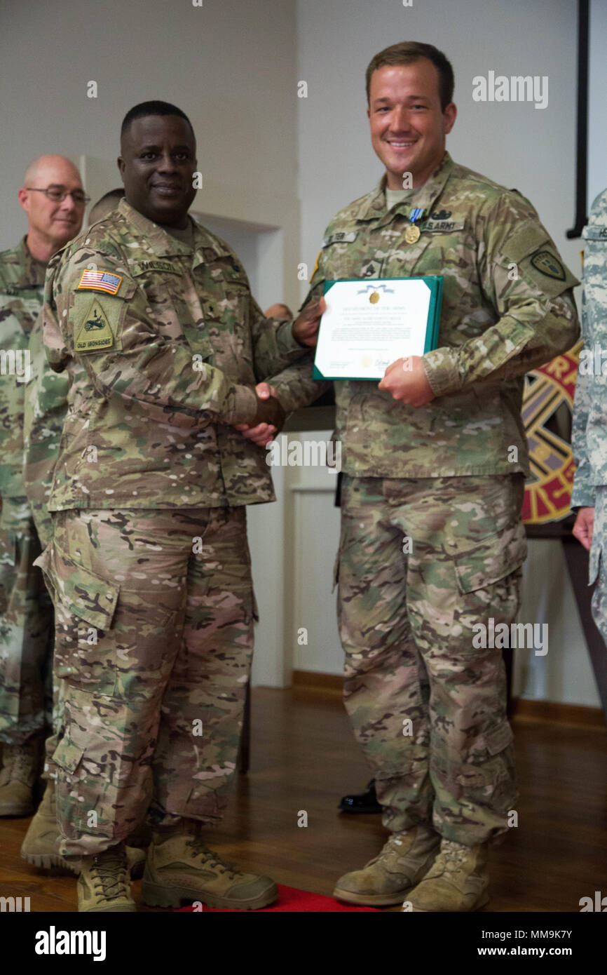 U.S. Army Brig. Gen. David Wilson, the 40th Chief of the Ordnance and Commandant of the United States Army Ordnance School, awards Sgt. Adam Ritter with the Army of Achievement Medal during the closing ceremony for the Explosive Ordnance Disposal (EOD) Team of the Year at Fort A.P. Hill, Va., Sept. 15, 2017. The U.S. Army Ordnance Crucible is a three-part competition, comprised of the Ammunition Transfer Holding Point, Combat Repair Team, and now on their final course the Explosive Ordnance Disposal, which is designed to get Soldiers' teamwork and critical thinking skills.  (U.S. Army photo by Stock Photo