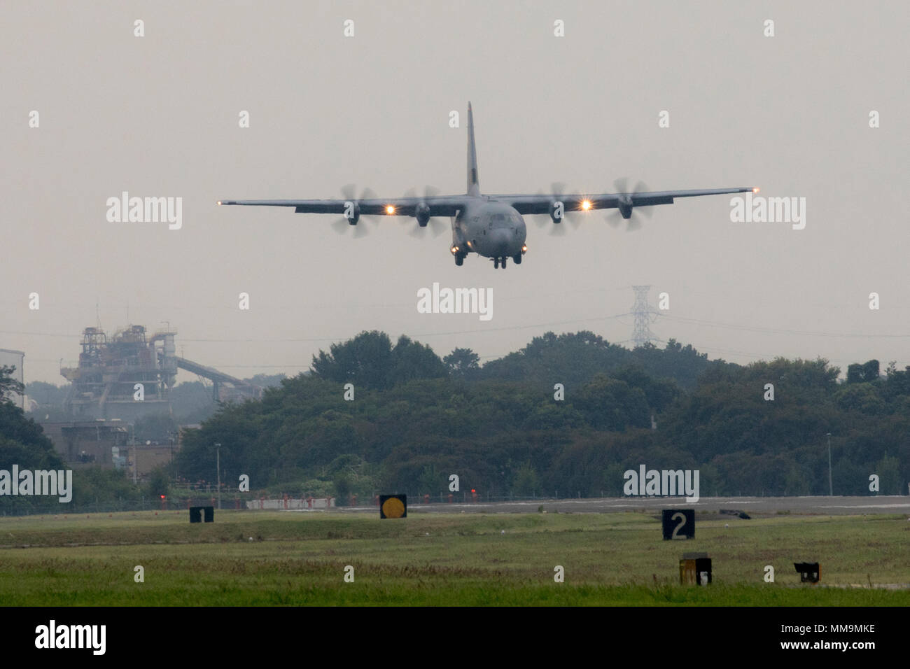 A C-130J Super Hercules approaches the runway at Yokota Air Base, Japan, Sept. 20, 2017. This is the fifth C-130J delivered to Yokota and the first from Ramstein Air Base, Germany. Crewmembers from the 36th Airlift Squadron flew halfway around the world to deliver this C-130J here. (U.S. Air Force photo by Yasuo Osakabe) Stock Photo