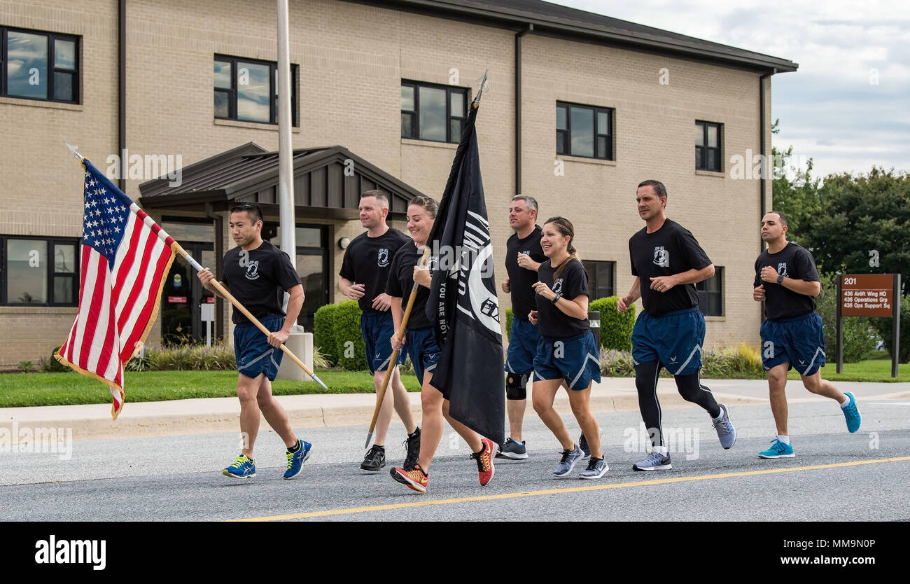 Col. Ethan Griffin, 436th Airlift Wing commander; Col. Corey Simmons, 436th AW vice commander; Chief Master Sgt. Sarah Sparks, 436th AW command chief; and four other members of Team Dover kick off the 24-hour run as part of the base’s two-day National Prisoner of War and Missing in Action Recognition Day events Sept. 14, 2017, on Dover Air Force Base, Del. A total of 343 runners participated in the 24-hour run that started at 4 p.m. and concluded Sept. 15 at 4 p.m. (U.S. Air Force photo by Roland Balik) Stock Photo