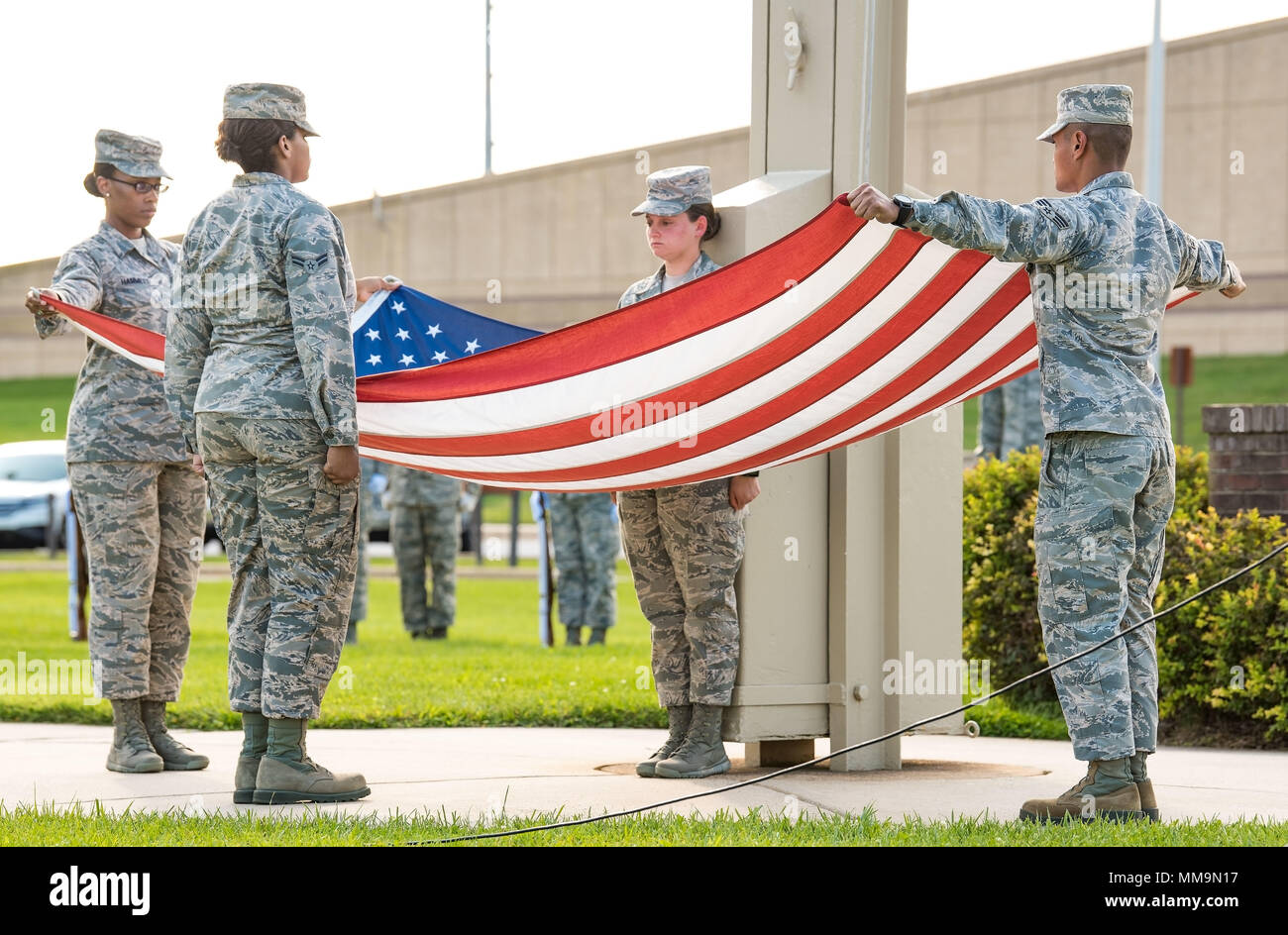 Members of the Dover Air Force Base Honor Guard prepare to fold the U.S. flag during the National Prisoner of War and Missing in Action Recognition Day ceremony Sept. 15, 2017, on Dover Air Force Base, Del. Positioned left to right, Senior Airman Kiara Hammett, 436th Aerospace Medical Squadron; Airman 1st Class Clair Boyles, 436th Logistics Readiness Squadron; Airman 1st Class Jessica Shaffer, 436th Operations Support Squadron; and Senior Airman Edcyril Mallonga, 436th Civil Engineer Squadron; presented the folded flag to Col. Corey Simmons, 436th Airlift Wing vice commander. (U.S. Air Force p Stock Photo