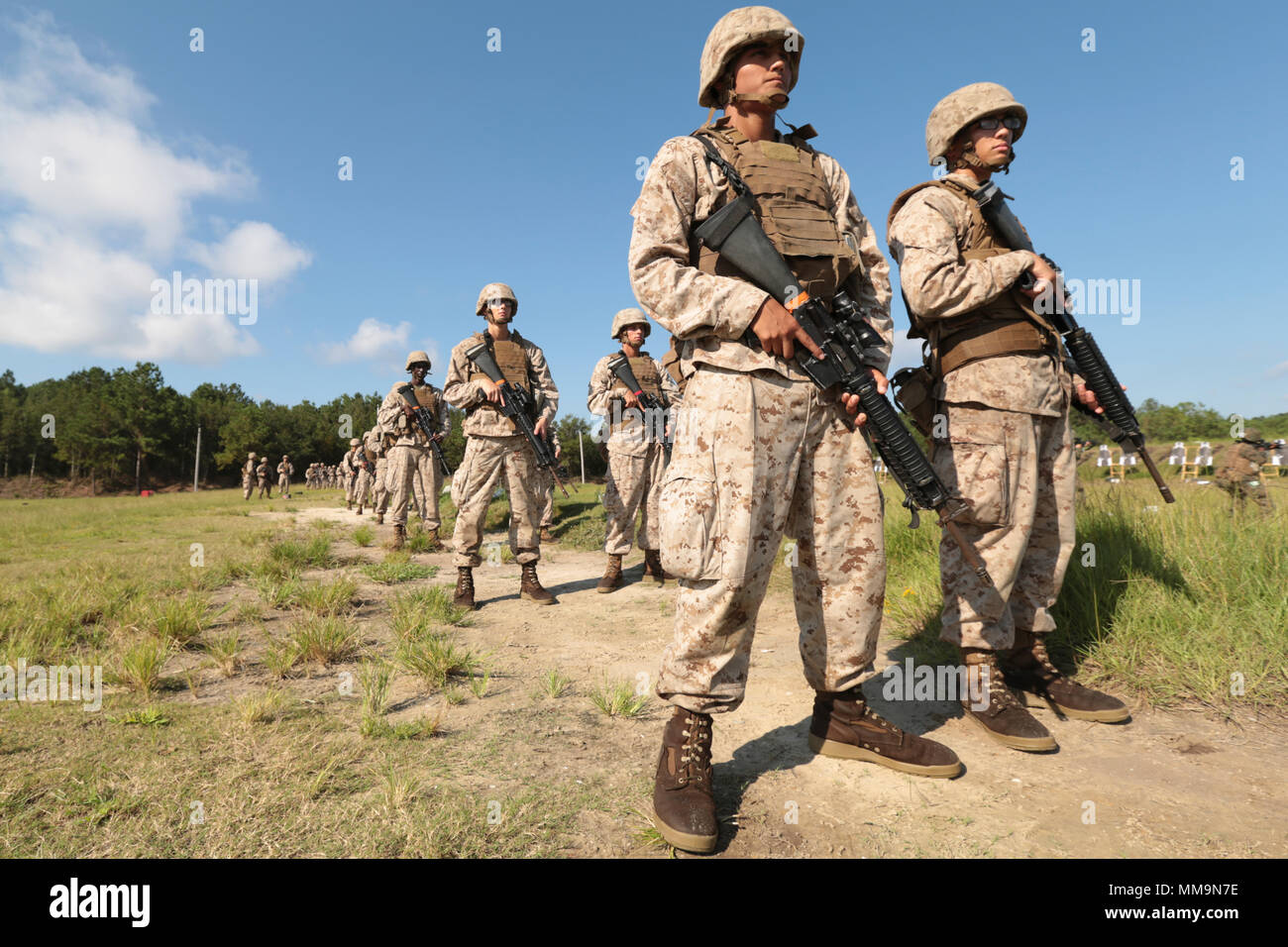 U.S. Marine Corps Rcts. Robert Howell (left), with platoon 2078, and John Hill with platoon 2076, Golf Company, 2nd Recruit Training Battalion, wait for instruction during Table 2 practice at Hue City Range on Marine Corps Recruit Depot, Parris Island, S.C., Sept. 14, 2017. Table two qualifications with the M16 Rifle teaches recruits to understand the weapon system in order to keep with the concept 'Every Marine a Rifleman'. (U.S. Marine Corps photo by Lance Cpl. Sarah Stegall/Released) Stock Photo