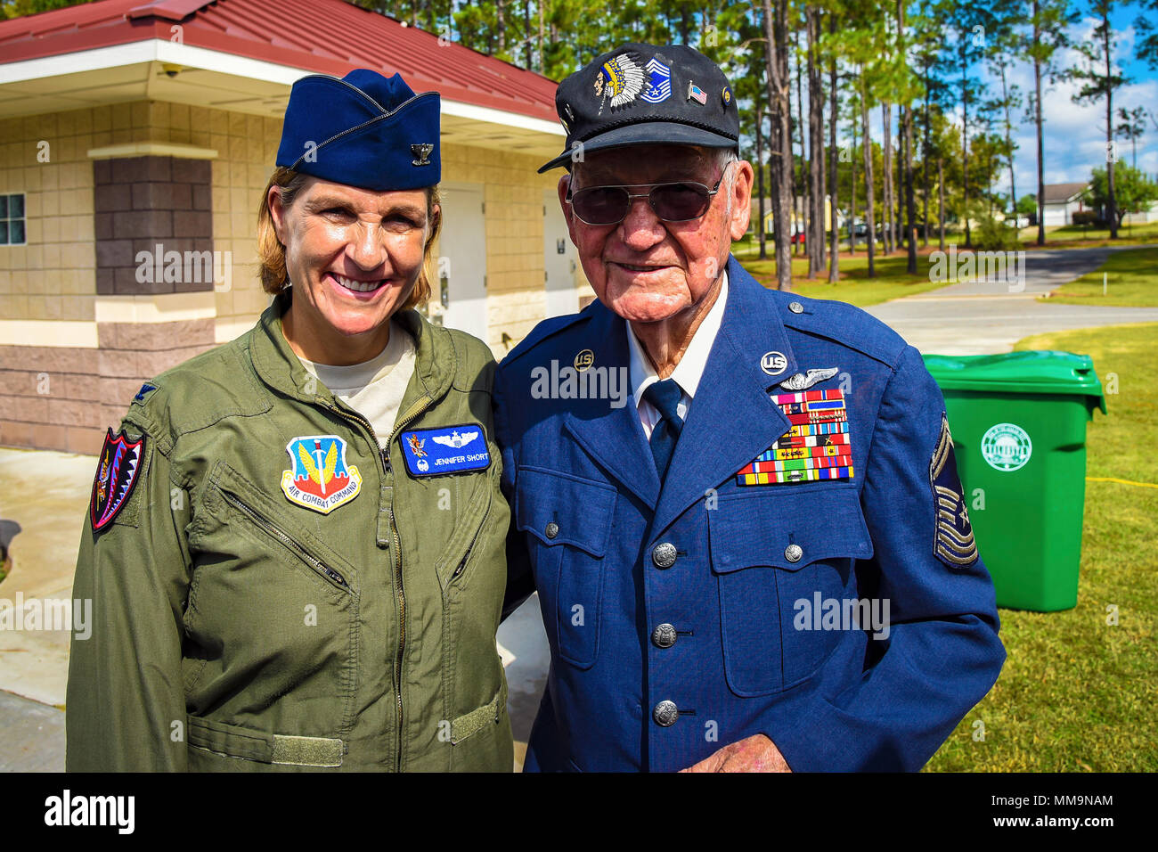 U.S. Air Force Col. Jennifer Short, 23d Wing commander, left, and retired  Chief Master Sgt. Jim E. Harring pose for a photo during an U.S. Air Force  70th birthday celebration, Sept. 16,