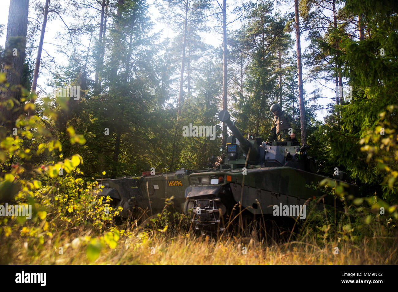 Swedish soldier changes turret position of the Swedish Strf-90 tracked infantry fighting vehicle during Exercise Aurora 17 in Lärbro, Sweden, Sept. 21, 2017. Aurora 17 is the largest Swedish national exercise in more than 20 years, and it includes supporting forces from the U.S. and other nations in order to exercise Sweden’s defense capability and promote common regional security. (U.S. Marine Corps photo by SSgt. Marcin Platek/Released) Stock Photo