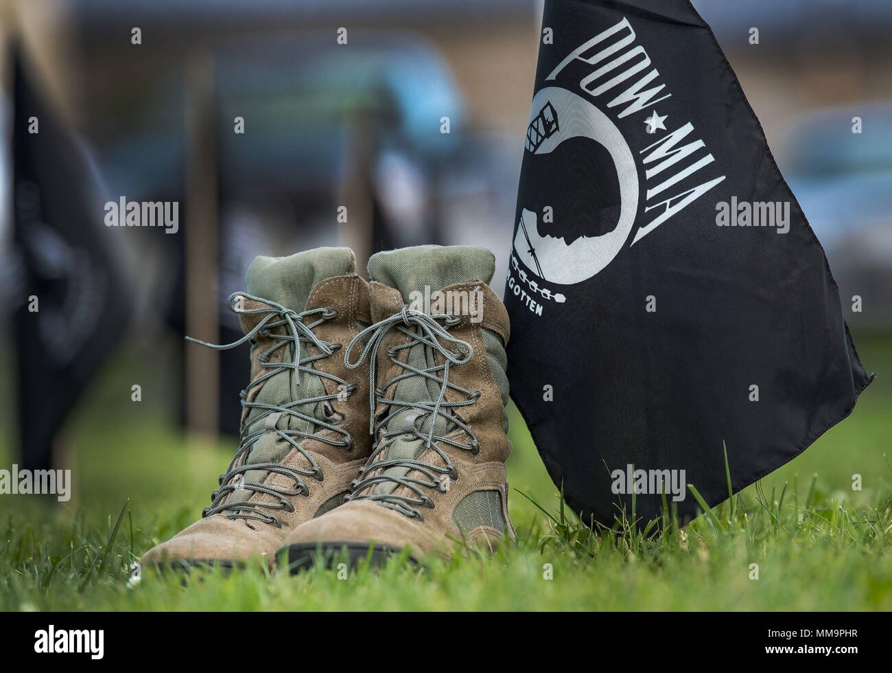 For a moment and hours prior to the National Prisoner of War and Missing in Action Recognition Day ceremony, a pair of boots sit beside a POW/MIA flag Sept. 15, 2017, on Dover Air Force Base, Del. A formation of 20 flags symbolized a flight made up of POW/MIA personnel and was placed between two Team Dover 20-man flights. (U.S. Air Force photo by Roland Balik) Stock Photo