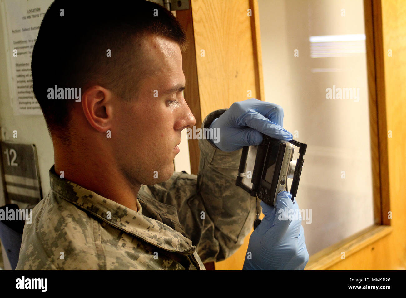 Arizona National Guardsman Sgt. Nicholas Jacobs photographs evidence during a forensic site exploitation exerise Sept. 18. Jacobs is one of 45 participants from across the U.S. Army to compete in the United States Army Military Police School's MP Competitive Challenge. (U.S. Army photo by Capt. Aaron Thacker) Stock Photo