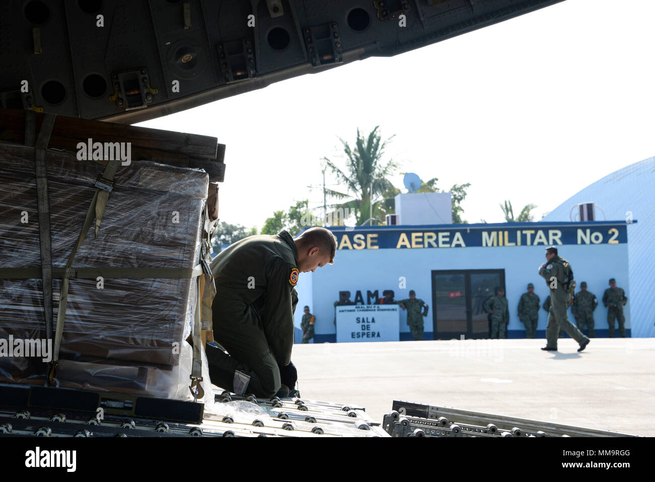 Senior Airman Dakota Maynor, 21st Airlift Squadron loadmaster, prepares to download pallets of cargo Sept. 22 at Ixetepec Airport, Oaxaca, Mexico. At the request of Mexican civil authorities, the C-17 and its six-member crew from Travis Air Force Base, Calif., assisted U.S. efforts to provide humanitarian aid to Mexico by airlifting over 31,000 pounds of hygiene and medical supplies to the area after a 7.1-magnitude earthquake struck Mexico City Sept. 19. (U.S. Air Force photo / 2nd Lt. Sarah Johnson) Stock Photo