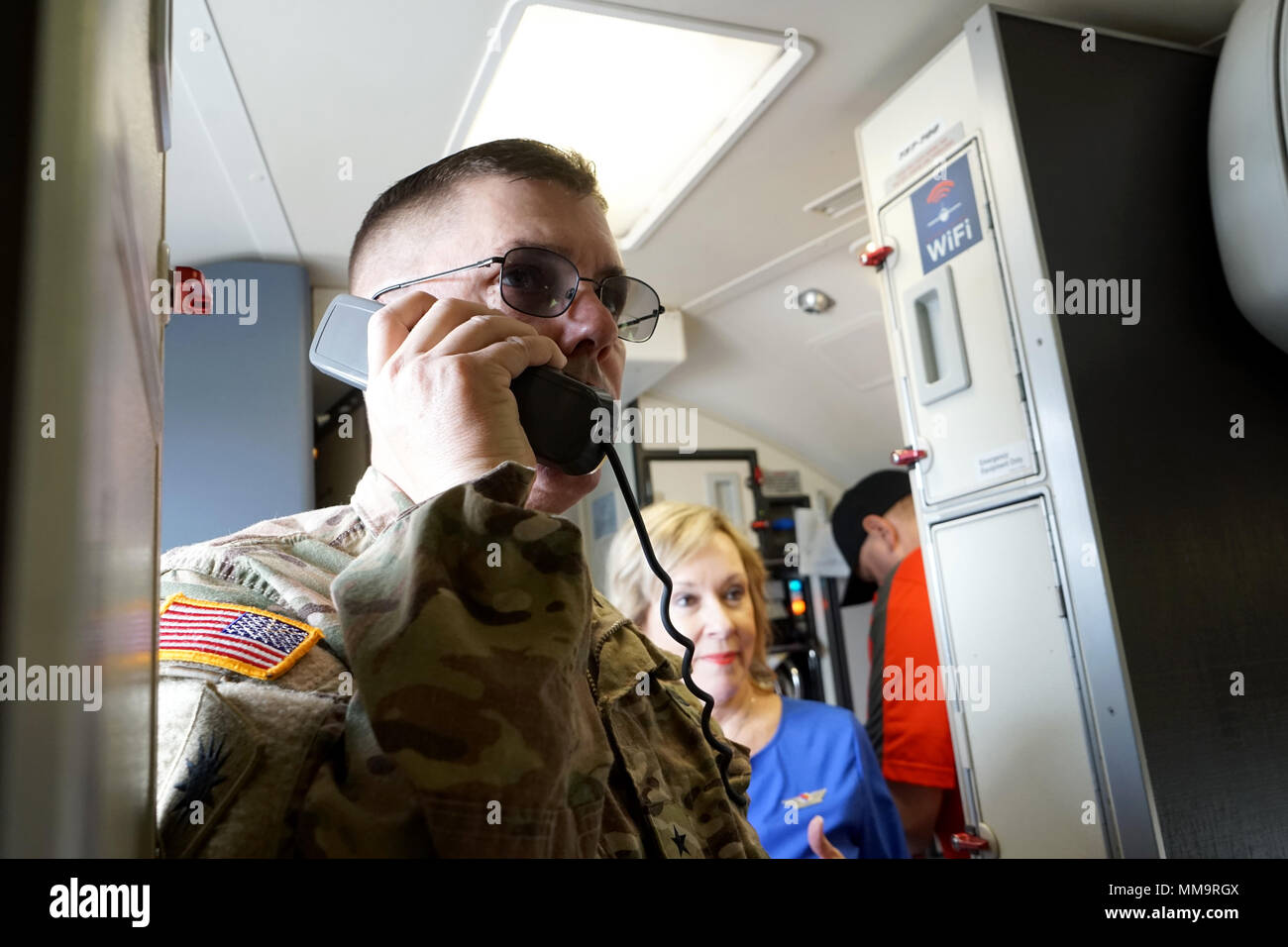 Brig. Gen. John W. Lathrop uses an intercom to share a motivational message with CalGuard Soldiers on a chartered plane at the Joint Force Training Base airfield in Los Alamitos, California, Sept. 18. Lathrop and  nearly 100 Guardsmen from the 40th Infantry Division’s Headquarters were headed to Fort Hood, Texas for the first phase of a yearlong deployment to Afghanistan. Stock Photo
