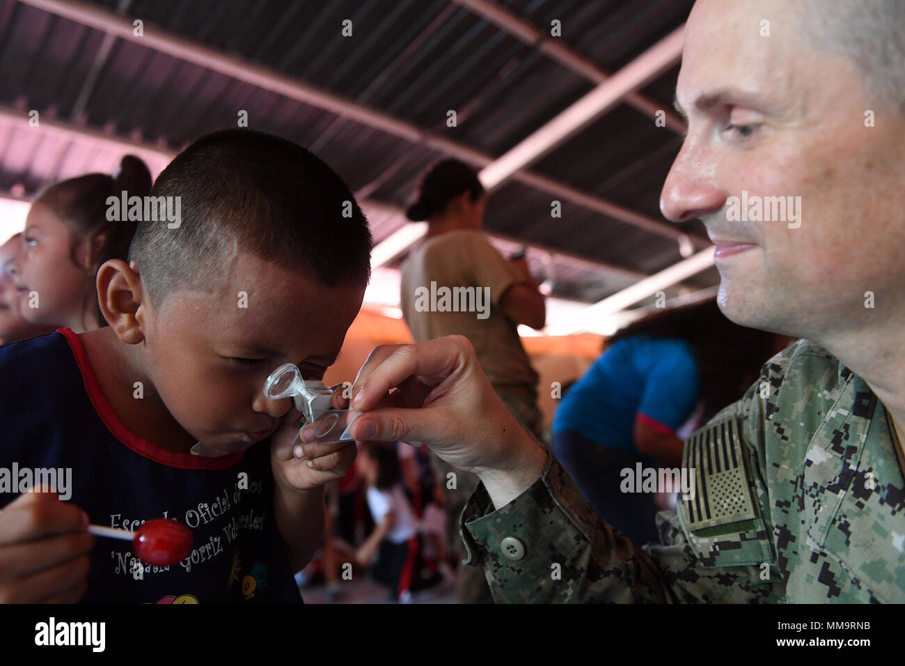 170922-N-BK435-0540 PUERTO BARRIOS, Guatemala (Sept. 22, 2017) Lt. Cmdr. Ian Sutherland, technical director for the Navy Entomology Center of Excellence, shows a student a mosquito specimen at Escuela Natalia Corriz Viuda de Morales, a Guatemalan primary school, during a Southern Partnership Station 17 community relations project (COMREL). SPS 17 is a U.S. Navy deployment executed by U.S. Naval Forces Southern Command/U.S. 4th Fleet, focused on subject matter expert exchanges with partner nation militaries and security forces in Central and South America. (U.S. Navy photo by Mass Communication Stock Photo