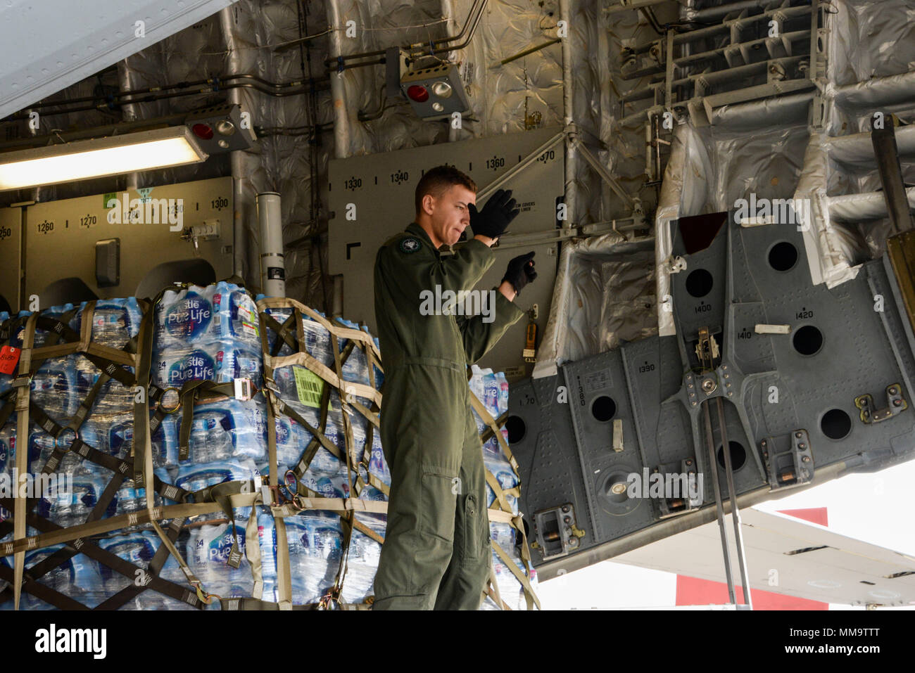 Senior Airman Dakota Maynor, 21st Airlift Squadron loadmaster, guides a forklift to the ramp of a C-17 Globemaster III to download cargo Sept. 23 at Benito Juárez International Airport, Mexico City, Mexico. At the request of the Mexican government, the C-17 and its six-member crew from Travis Air Force Base, Calif., assisted U.S. efforts to provide aid to Mexico by airlifting over 130,000 pounds of food, water, hygiene and medical supplies to Mexico City and Oaxaca after a 7.1-magnitude earthquake struck the area Sept. 19. (U.S. Air Force photo / 2nd Lt. Sarah Johnson) Stock Photo