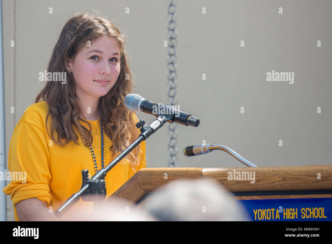 Sarah Heino, Yokota High School student body president, speaks to the audience during the Yokota High School ribbon cutting ceremony, Sept. 25, 2017, at Yokota Air Base, Japan. The Yokota High School’s mascot is the panther and the school’s motto is, “Life is about chances and opportunities. Never leave anything to chance and never let an opportunity get away.” – Lily Tomlin. (U.S. Air Force photo by Airman 1st Class Donald Hudson) Stock Photo