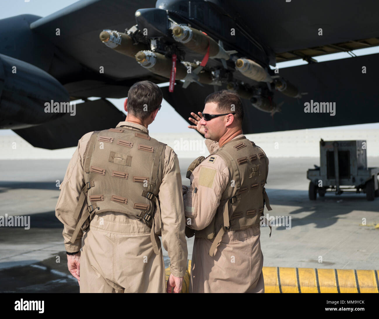 U.S. Air Force Capt. Micah McCracken, right, 69th Expeditionary Bomb Squadron aircraft commander, discusses the B-52 Stratofortress to U.S. Army Gen. Joseph Votel, left, U.S. Central Command commander, at Al Udeid Air Base, Qatar, Sept. 8, 2017.  Votel flew on a combat mission aboard a B-52 Stratofortress, and spent time talking with deployed Airmen at the 69th Expeditionary Bomb Squadron here. (U.S. Air Force photo by Tech. Sgt. Amy M. Lovgren) Stock Photo