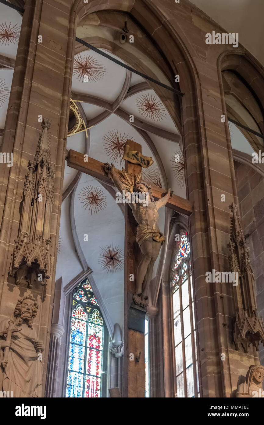 Photograph of a statue depicting the crucifiction of Christ from the interior of the Strasbourg Cathedral.  Work on the cathedral was started in 1015  Stock Photo