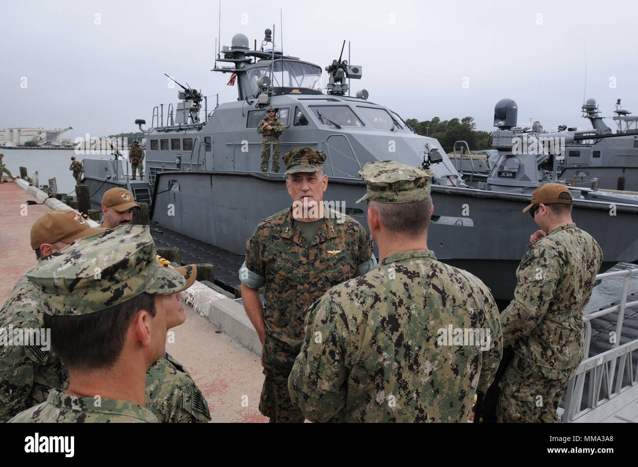 VIRGINIA BEACH, VA (September 26, 2017) - Maj. Gen. David Coffman, director of Expeditionary Warfare, Office of the Chief of Naval Operations, meets with staff of Coastal Riverine Group 2 (CRG 2) prior to a tour of the Mark VI patrol boat during a visit to Navy Expeditionary Combat Command (NECC).  NECC organizes, mans, trains, equips and sustains Navy Expeditionary Combat Forces to execute combat, combat support, and combat service support missions across the full spectrum of naval, joint, and combined operations. (U.S. Navy photo by Chief Mass Communication Specialist Edward Kessler/Released Stock Photo