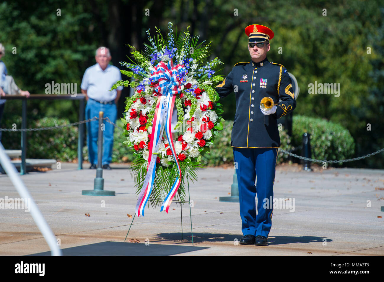 A bugler from The U.S. Army Band, 'Pershing's Own', stands with the wreath to be laid by His Excellency Peter M. Christian, president, Federated States of Micronesia.  President Christian also toured the Memorial Amphitheater Display Room and exchanged gifts with Mr. Brion Moore, deputy superintendent, Arlington National Cemetery.  (U.S. Army photo by Elizabeth Fraser / Arlington National Cemetery / released) Stock Photo