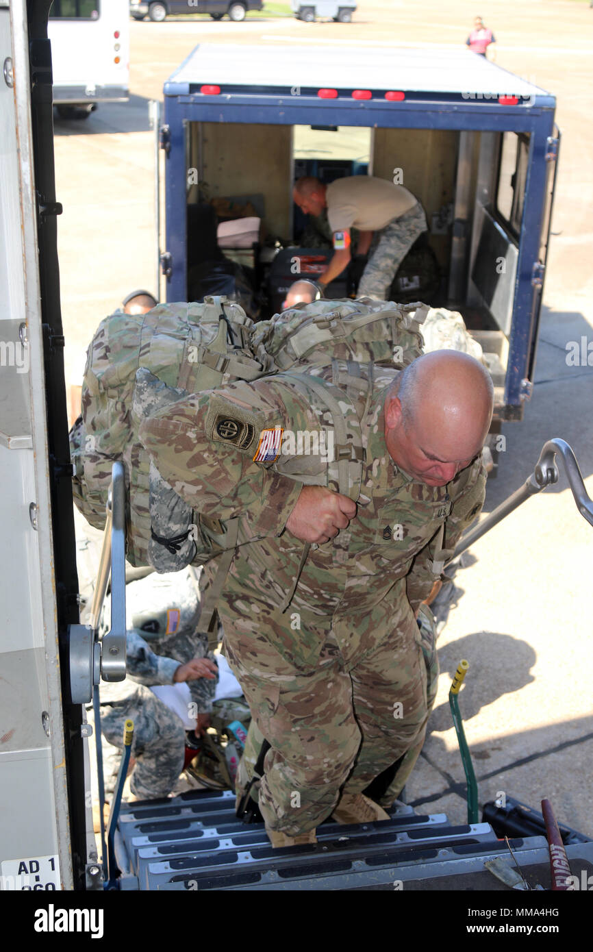 Sergeant 1st Class Charles Connell, of Headquarters and Headquarters Company, 184th Sustainment Command, boards a C-17 Globemaster III of the 183d Airlift Squadron, 172d Airlift Wing, at Thompson Field in Flowood, Miss., Sept. 28, 2017. More than 200 Mississippi Guardsmen are deploying to assist hurricance relief efforts in Puerto Rico and the U.S. Virgin Islands. The 184th SC is headquartered in Laurel, Miss. The 172d is headquartered at Thompson Field. (U.S. Army photo by Staff Sgt. Scott Tynes) Stock Photo