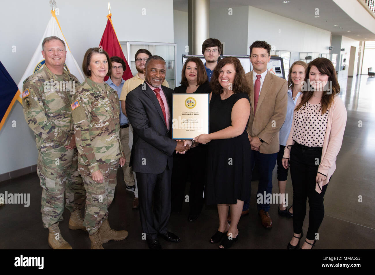 Mr. Eugene Collins, Deputy Assistant Secretary of the Army (Environment, Safety, and Occupational Health) presents the Secretary of the Army Environmental Award to the Cultural Resources Managment Team along with Maj. Gen. Sheryl Gordon, Alabama National Guard adjutant General, and Col. Philip Clayton, Alabama National Guard construction and facilities management officer at Alabama National Guard Joint Force Headquarters in Montgomery, Alabama, Sept. 27, 2017. (Photo by Army Sgt. William Frye). Stock Photo