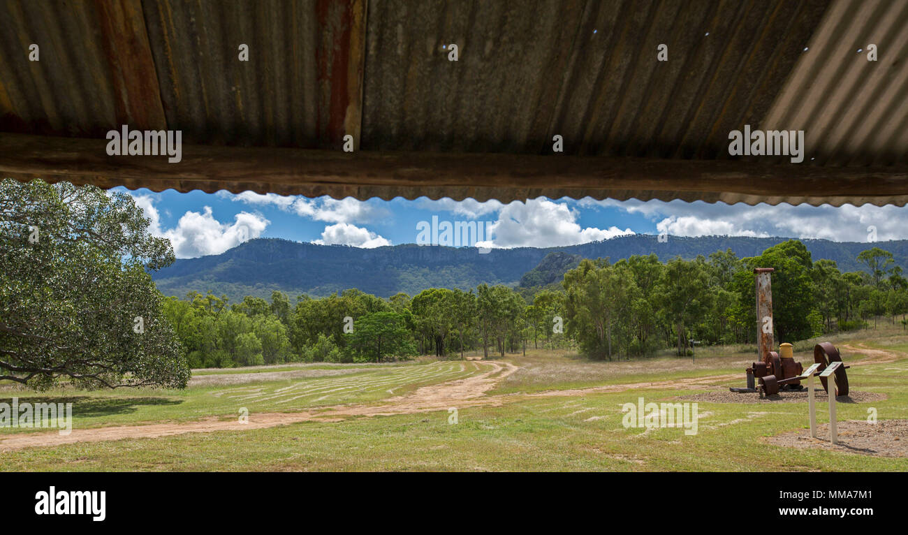 Panoramic view of site of historic mining town of Mount Britton with relics of past beside woodlands at foot of Great Dividing Range under blue sky Stock Photo