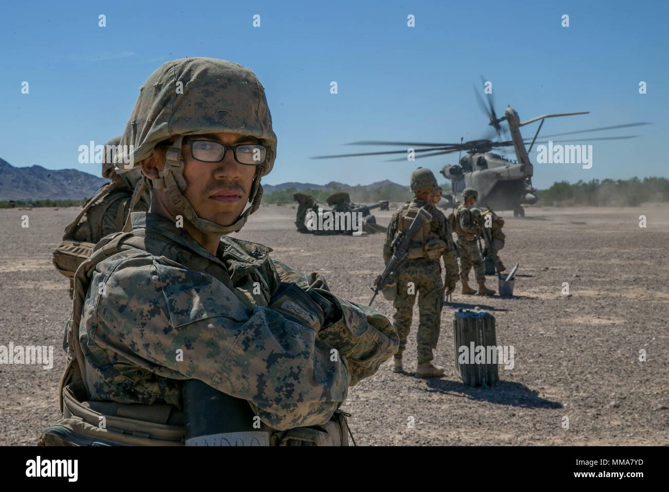 U.S. Marine Corps Lance Cpl. Francisco Munguiaandrade, a field artillery Marine with Echo Battery, 2nd Battalion, 11th Marine Regiment, awaits the landing of a CH-53E Super Stallion during Weapons and Tactics Instructors Course (WTI) 1-18 at Yuma, Ariz., on Sept. 30, 2017. WTI is a seven week training event hosted by Marine Aviation and Weapons Tactics Squadron One (MAWTS-1) cadre which emphasizes operational integration of the six functions of Marine Corps Aviation in support of a Marine Air Ground Task Force. MAWTS-1 provides standardized advanced tactical training and certification of unit  Stock Photo