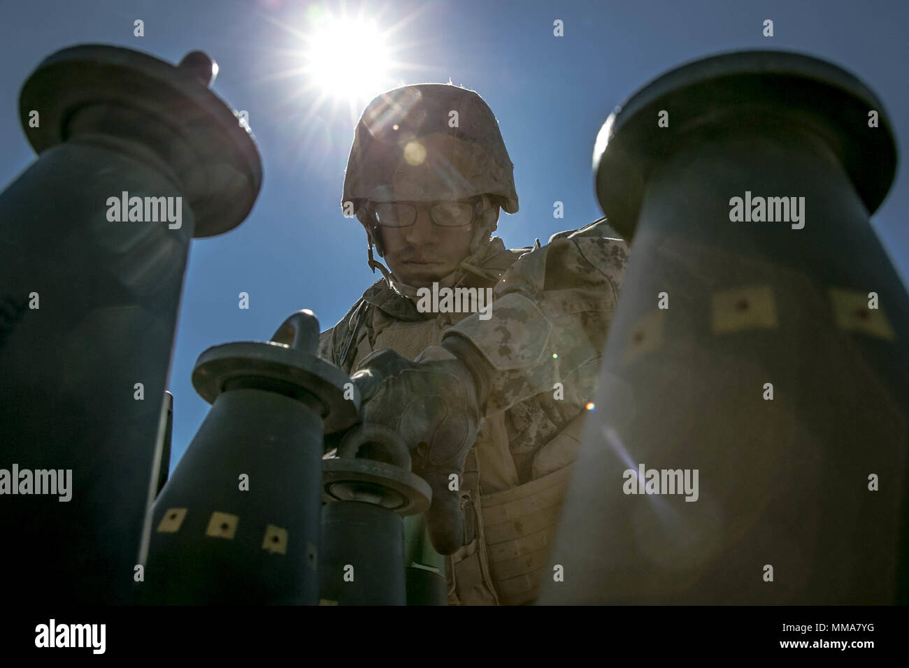 U.S. Marine Corps Lance Cpl. Francisco Munguiaandrade, a field artillery Marine with Echo Battery, 2nd Battalion, 11th Marine Regiment, prepares ammunition for a M777 towed 155 mm howitzer during Weapons and Tactics Instructors Course (WTI) 1-18 at Yuma, Ariz., on Sept. 30, 2017. WTI is a seven week training event hosted by Marine Aviation and Weapons Tactics Squadron One (MAWTS-1) cadre which emphasizes operational integration of the six functions of Marine Corps Aviation in support of a Marine Air Ground Task Force. MAWTS-1 provides standardized advanced tactical training and certification o Stock Photo