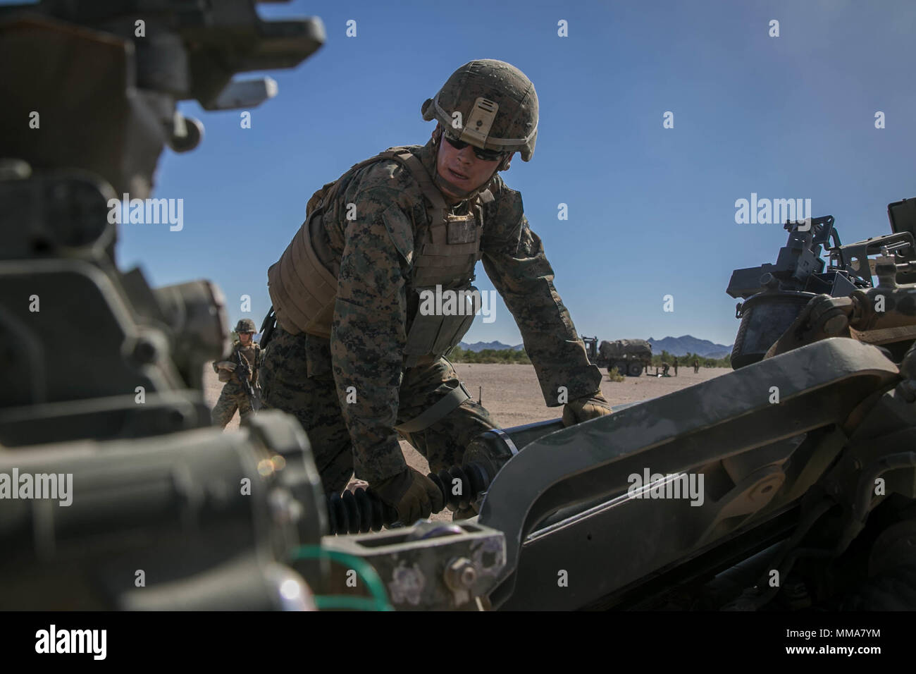 U.S. Marine Corps Cpl. Seth Hagen a field artillery Marine with Echo Battery, 2nd Battalion, 11th Marine Regiment, cleans a M777 towed 155 mm howitzer during Weapons and Tactics Instructors Course (WTI) 1-18 at Yuma, Ariz., on Sept. 30, 2017. WTI is a seven week training event hosted by Marine Aviation and Weapons Tactics Squadron One (MAWTS-1) cadre which emphasizes operational integration of the six functions of Marine Corps Aviation in support of a Marine Air Ground Task Force. MAWTS-1 provides standardized advanced tactical training and certification of unit instructor qualifications to su Stock Photo