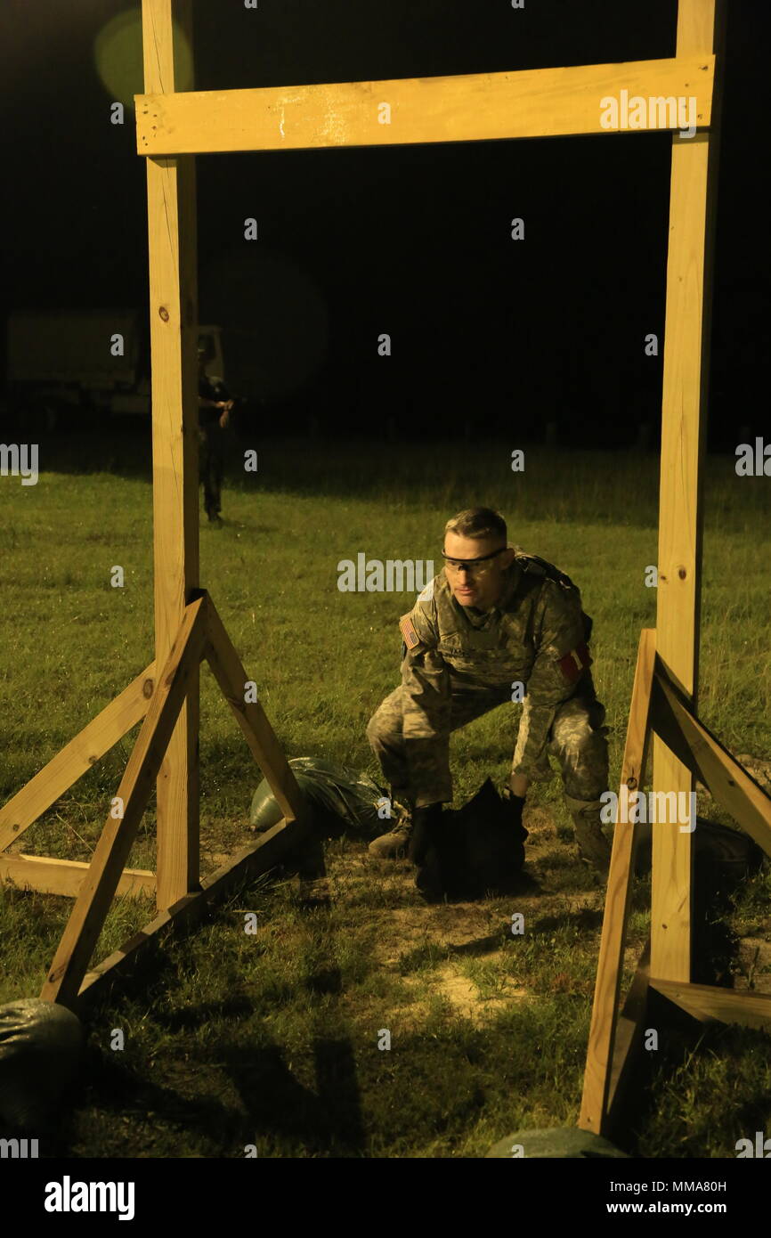 U.S. Army Staff Sgt. Steven Vasko, assigned to the Keller Army Community Hospital, prepares to toss a sand bag over a beam during the 2017 Best Medic Competition at Fort Bragg, N.C., Sep. 18-21, 2017. The competition tested the physical and mental toughness, as well as the technical competence, of each medic to identify the team moving forward to represent the region at the next level of the competition.  (U.S. Army photo by Spc. Paris Maxey) Stock Photo