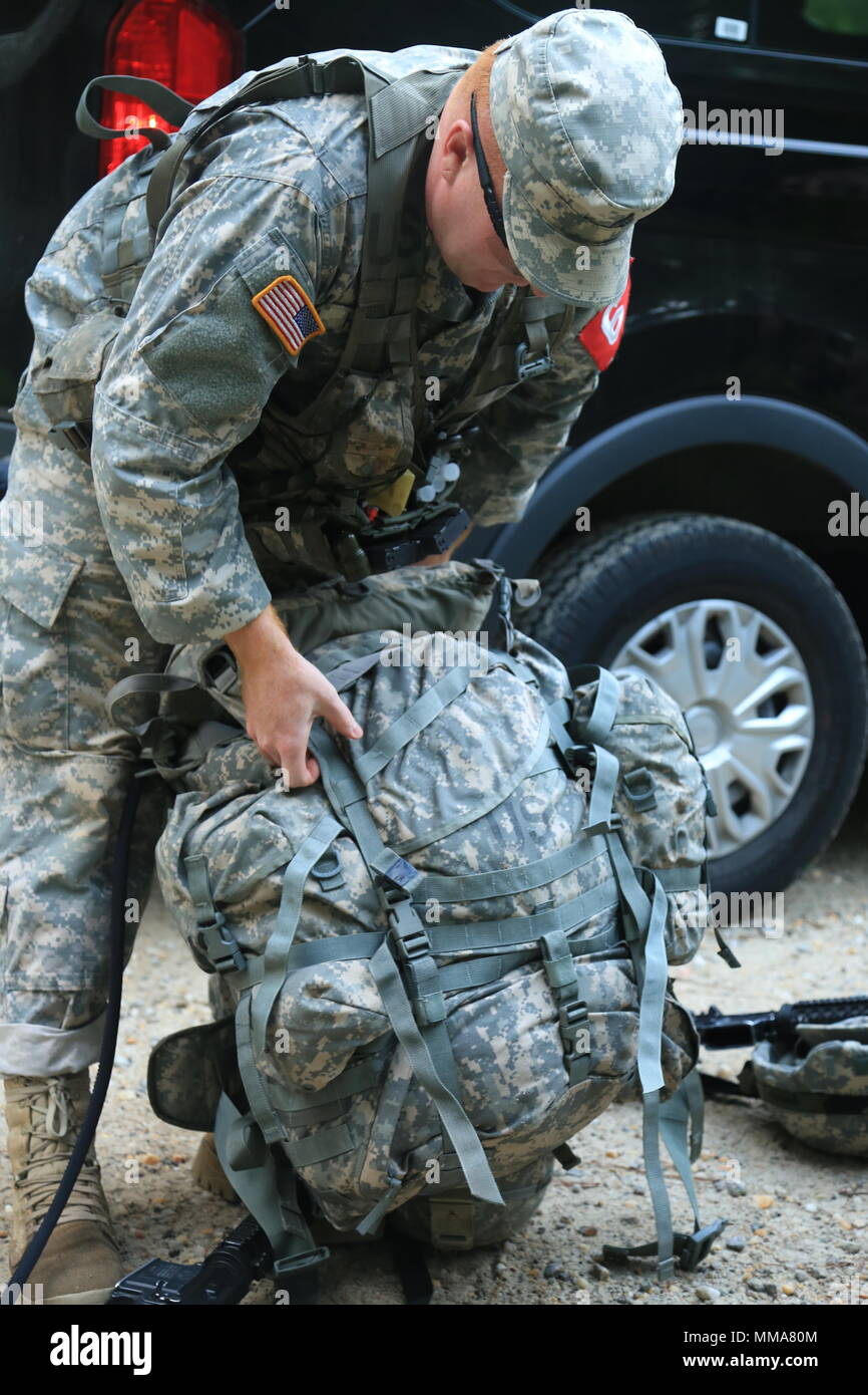 U.S. Army Sgt. David Hauger, assigned to the Womack Army Medical Center, preps his ruck sack for a foot march during the 2017 Best Medic Competition at Fort Bragg, N.C., Sep. 18-21, 2017. The competition tested the physical and mental toughness, as well as the technical competence, of each medic to identify the team moving forward to represent the region at the next level of the competition.  (U.S. Army photo by Spc. Paris Maxey) Stock Photo