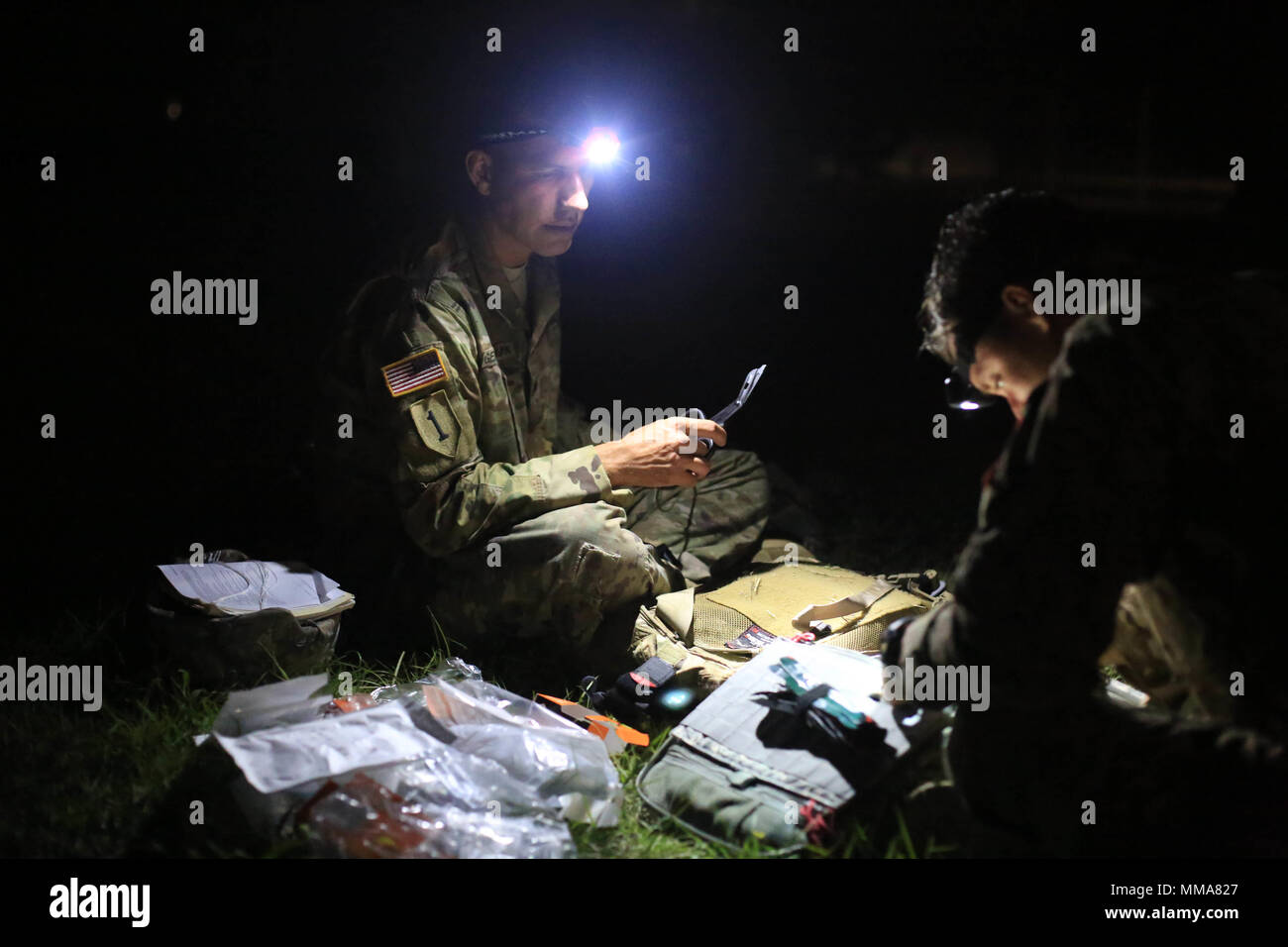 U.S. Army Staff Sgt. Eric Jonier and Staff Sgt. Mkakauet Generauax, both assigned to the Lyster Army Community Hospital, pack their medical bags before the simulated Mass Casualty Event during the 2017 Best Medic Competition at Fort Bragg, N.C., Sep. 18-21, 2017. The competition tested the physical and mental toughness, as well as the technical competence, of each medic to identify the team moving forward to represent the region at the next level of the competition.  (U.S. Army photo by Spc. Paris Maxey) Stock Photo