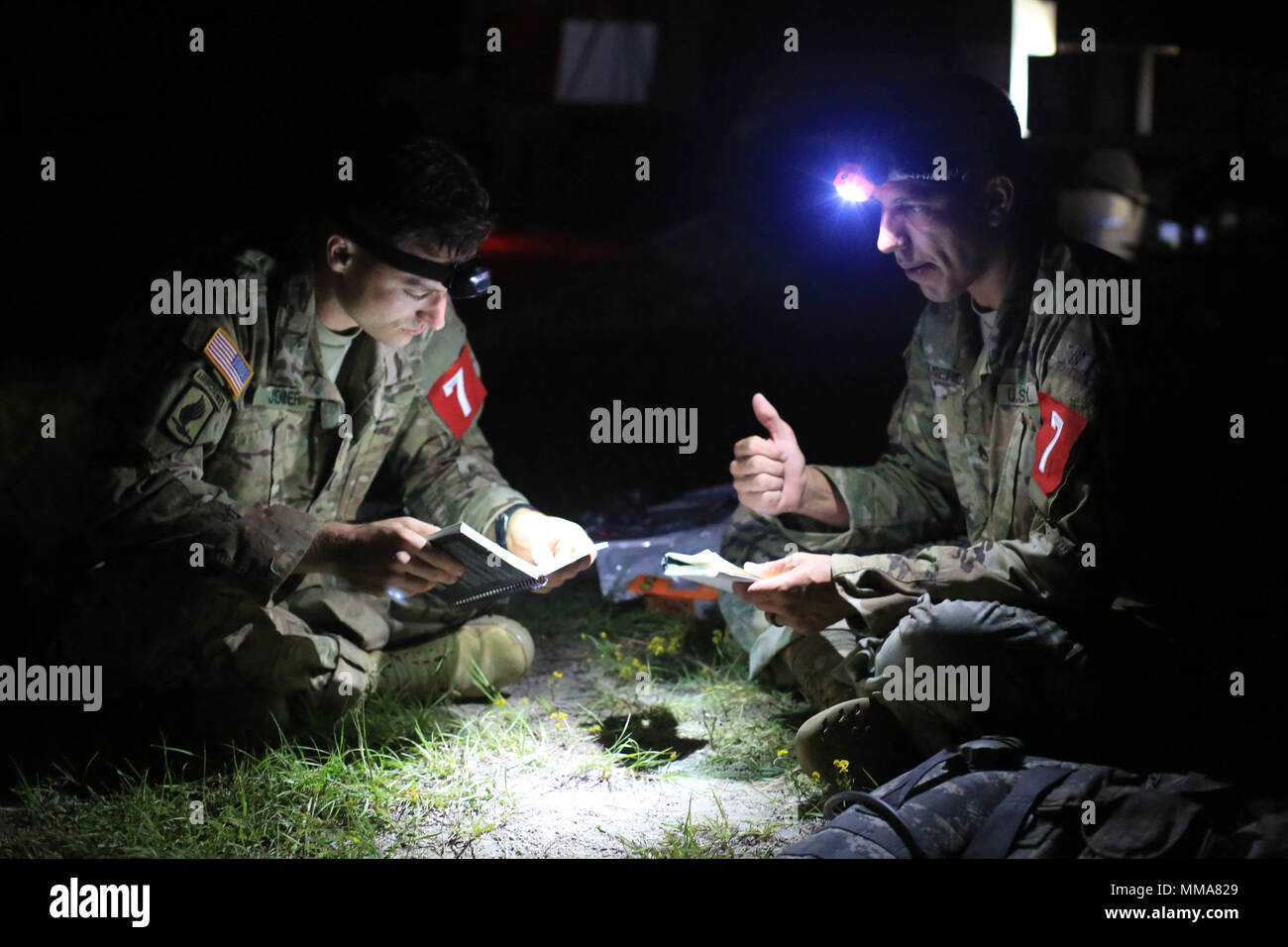 U.S. Army Staff Sgt. Eric Jonier and Staff Sgt. Mkakauet Generauax, both assigned to the Lyster Army Community Hospital, look over notes before the simulated Mass Casualty Event during the 2017 Best Medic Competition at Fort Bragg, N.C., Sep. 18-21, 2017. The competition tested the physical and mental toughness, as well as the technical competence, of each medic to identify the team moving forward to represent the region at the next level of the competition.  (U.S. Army photo by Spc. Paris Maxey) Stock Photo