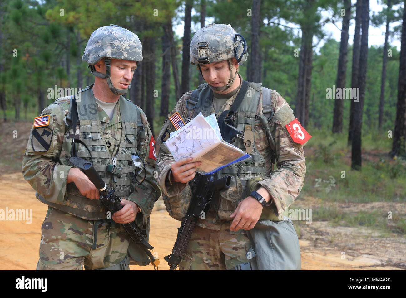 U.S. Army Sgt. 1st Class Zachary Dispennette and Sgt. Christopher Faulkner, both assigned to the McDonald Army Health Center, discuss a plan during the 2017 Best Medic Competition at Fort Bragg, N.C., Sep. 18-21, 2017. The competition tested the physical and mental toughness, as well as the technical competence, of each medic to identify the team moving forward to represent the region at the next level of the competition.  (U.S. Army photo by Spc. Paris Maxey) Stock Photo