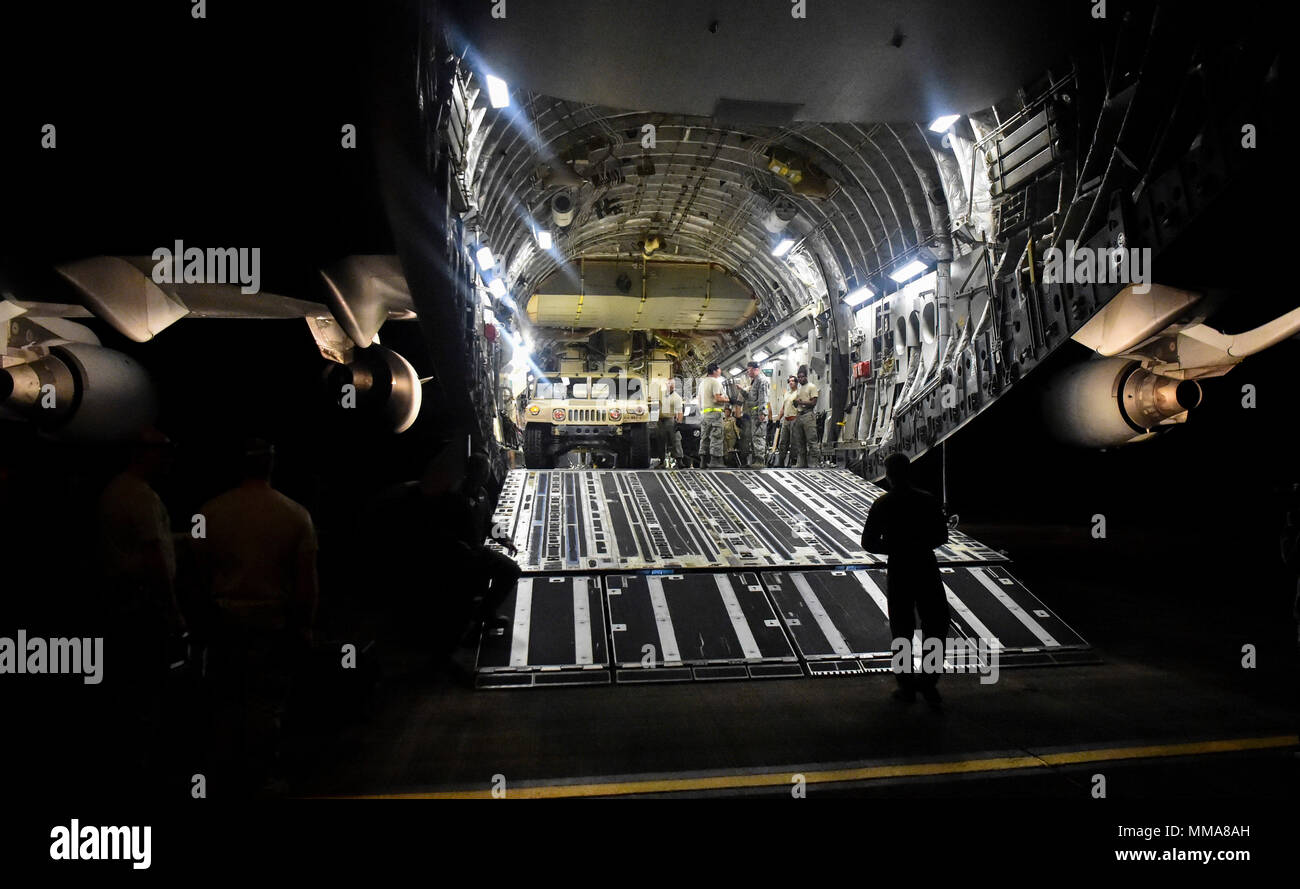 A Humvee is offloaded from a C-17 Globemaster III at Ceiba, Puerto Rico, Sept. 29, 2017. Three Humvees and 12 Army Soldiers were taken to Ceiba, Puerto Rico to help distribute supplies to those affected by Hurricane Maria. The 15th Airlift Squadron and 437th Airlift Wing worked alongside the Army's 510th Human Resources Company to deliver relief to Puerto Rico. Hurricane Maria made landfall in Puerto Rico on Sept. 20, 2017 leaving millions without power and food or water.  (U.S. Air Force photo by Senior Airman Christian Sullivan) Stock Photo