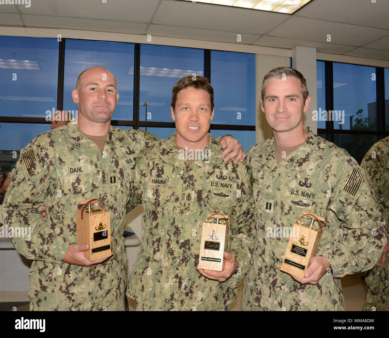 SAN DIEGO (Sept. 20, 2017) Rear Adm. Brian Brakke, commander of Navy Expeditionary Combat Command (NECC)  presented Lt. Morgan Dahl (left) the Rear Adm. Draper L. Kauffman leadership award, Explosive Ordnance Disposal Senior Chief Jonathan Hamm (middle) with the Force Master Chief Anthony Santino Leadership, and Lt. Wayne Mcelmoyl (right) with the Cmdr. Kevin Childre Excellence award during an award ceremony at Explosive Ordnance Disposal (EOD) Mobile Unit Three aboard Naval Base Coronado, Sept. 20. U.S. Navy EOD is the world's premier combat force for countering explosive hazards and conducti Stock Photo