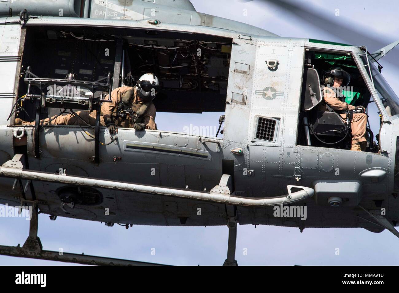 170928-N-BK384-408 MEDITERRANEAN SEA (Sept. 28, 2017) U.S. Marine Lance Cpl. Kane Hensley, from Virginia Beach, Virginia, and assigned to Marine Medium Tiltrotor Squadron (VMM) 161 (reinforced), checks the distance from the helicopter to the flight deck of the San Antonio-class amphibious transport dock ship USS San Diego (LPD 22) during flight operations Sept. 28, 2017. San Diego is deployed with the America Amphibious Ready Group and the 15th Marine Expeditionary Unit to support maritime security and theater security cooperation in efforts in the U.S. 6th Fleet area of operations. (U.S. Navy Stock Photo
