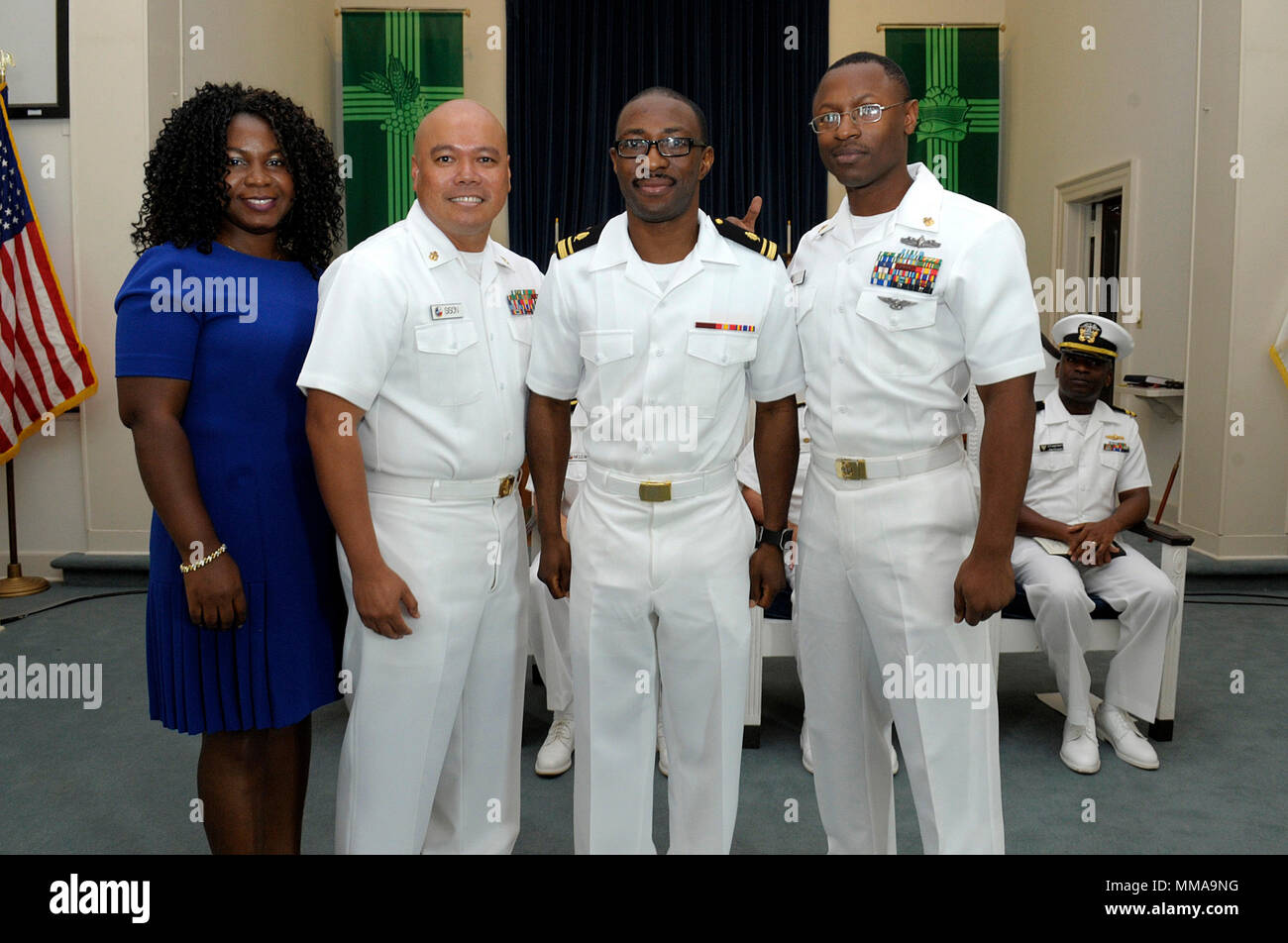 CORPUS CHRISTI, Texas – Lt. j.g. Emmanuel T. Dadzie, from Accra, Ghana, West Africa, becomes a Medical Service Corps officer during a Naval Health Clinic Corpus Christi commissioning ceremony Oct. 2, 2017. His wife participates with Chief Hospital Corpsman Tirso R. Sison and Chief Information Systems Technician Trevor J. Wilmer (right) in the presentation of shoulder boards to the former Hospital Corpsman 2nd Class. (U.S. Navy photo by Bill W. Love/RELEASED) 171002-N-KF478-156 Stock Photo