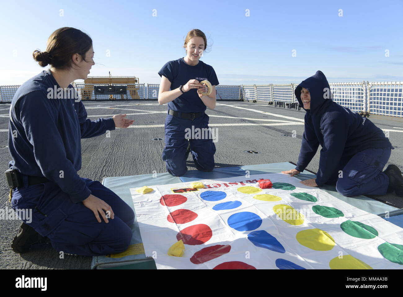 Coast Guard crew members prepare a game on the flight deck as part of a ...