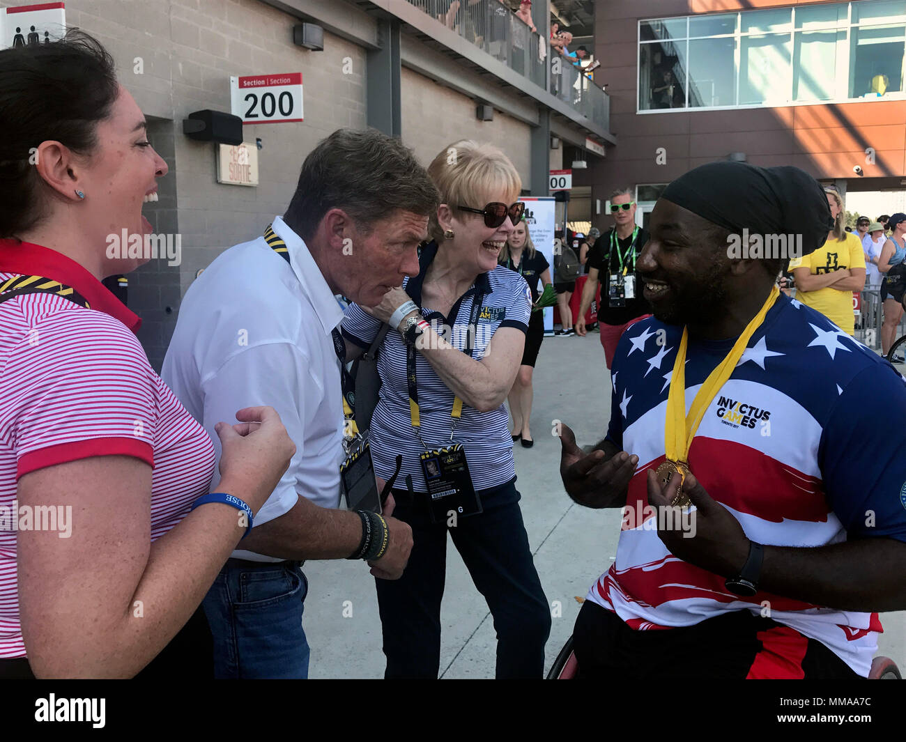 Ken Fisher, CEO and founder of Fisher House, jokes with medically retired Army Spc. Tony Pone, after he earned gold medals in his disability category in the men’s discus and shot put during the 2017 Invictus Games in Toronto Sept. 24, 2017. The Invictus Games, established by Prince Harry in 2014, brings together wounded and injured veterans from 17 nations for 12 adaptive sporting events, including track and field, wheelchair basketball, wheelchair rugby, swimming, sitting volleyball, and new to the 2017 games, golf. (DoD photo by Shannon Collins) Stock Photo