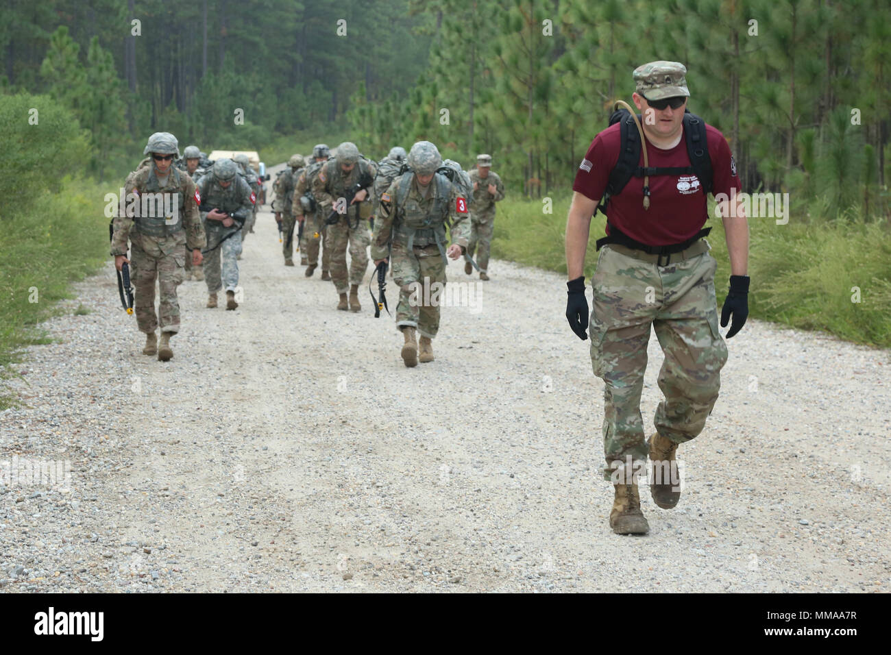 U.S. Soldiers, competing in the 2017 Best Medic Competition, participate in a ruck march during the 2017 Best Medic Competition at Fort Bragg, N.C., Sept. 18, 2017. The competition tested the physical and mental toughness, as well as the technical competence, of each medic to identify the team moving forward to represent the region at the next level of the competition.  (U.S. Army photo by Pfc. Meleesa Gutierrez) Stock Photo