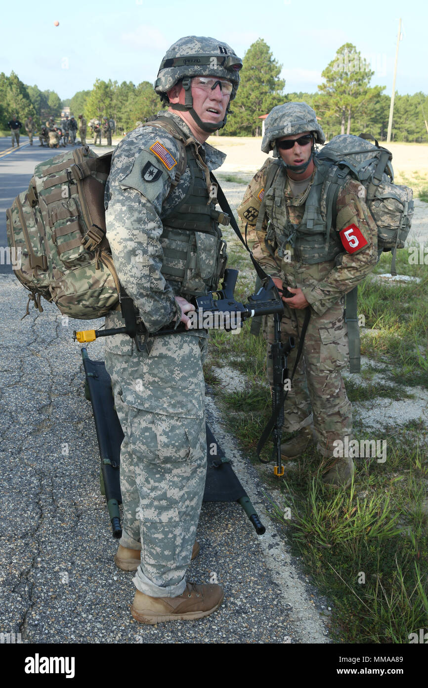 U.S. Army Capt. Jeremy Lewis and Staff Sgt. Joseph Karslo, assigned to the Public Health Command - Atlantic,look ahead to see the finish line during the 2017 Best Medic Competition at Fort Bragg, N.C., Sept. 18, 2017.The competition tested the physical and mental toughness, as well as the technical competence, of each medic to identify the team moving forward to represent the region at the next level of the competition.  (U.S. Army photo by Pfc. Meleesa Gutierrez) Stock Photo