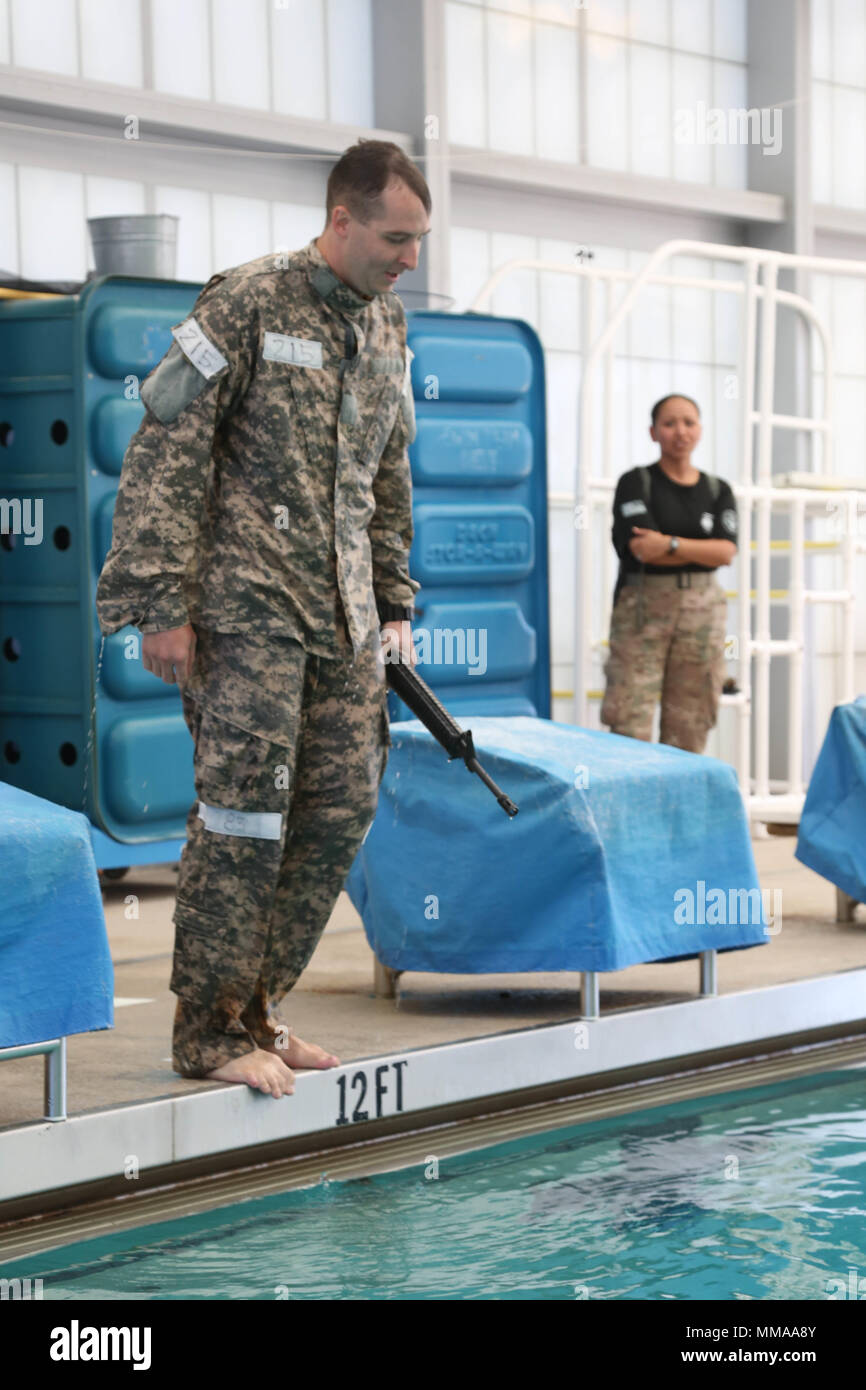 U.S. Army Sgt. Christopher Faulkner, assigned to the McDonald Army Health Center, prepares to step into the pool during the 2017 Best Medic Competition at Fort Bragg, N.C., Sept. 19, 2017. The competition tested the physical and mental toughness, as well as the technical competence, of each medic to identify the team moving forward to represent the region at the next level of the competition.  (U.S. Army photo by Pfc. Meleesa Gutierrez) Stock Photo