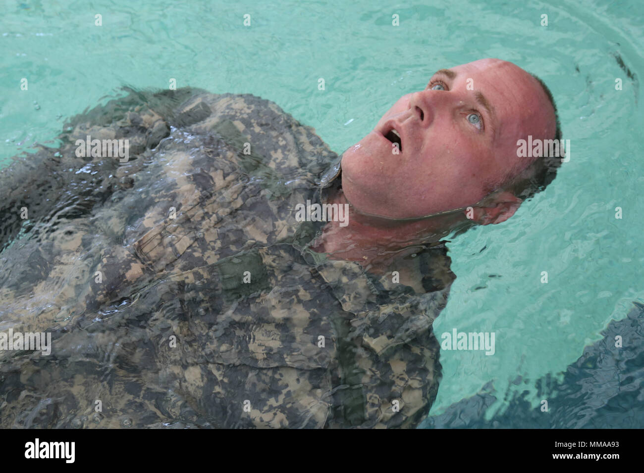 U.S. Army Staff Sgt. Eric Sullivan, assigned to the Blanchfield Army Community Hospital, swims backwards during the water survival portion of the 2017 Best Medic Competition at Fort Bragg, N.C., Sept. 19, 2017. The competition tested the physical and mental toughness, as well as the technical competence, of each medic to identify the team moving forward to represent the region at the next level of the competition.  (U.S. Army photo by Pfc. Meleesa Gutierrez) Stock Photo
