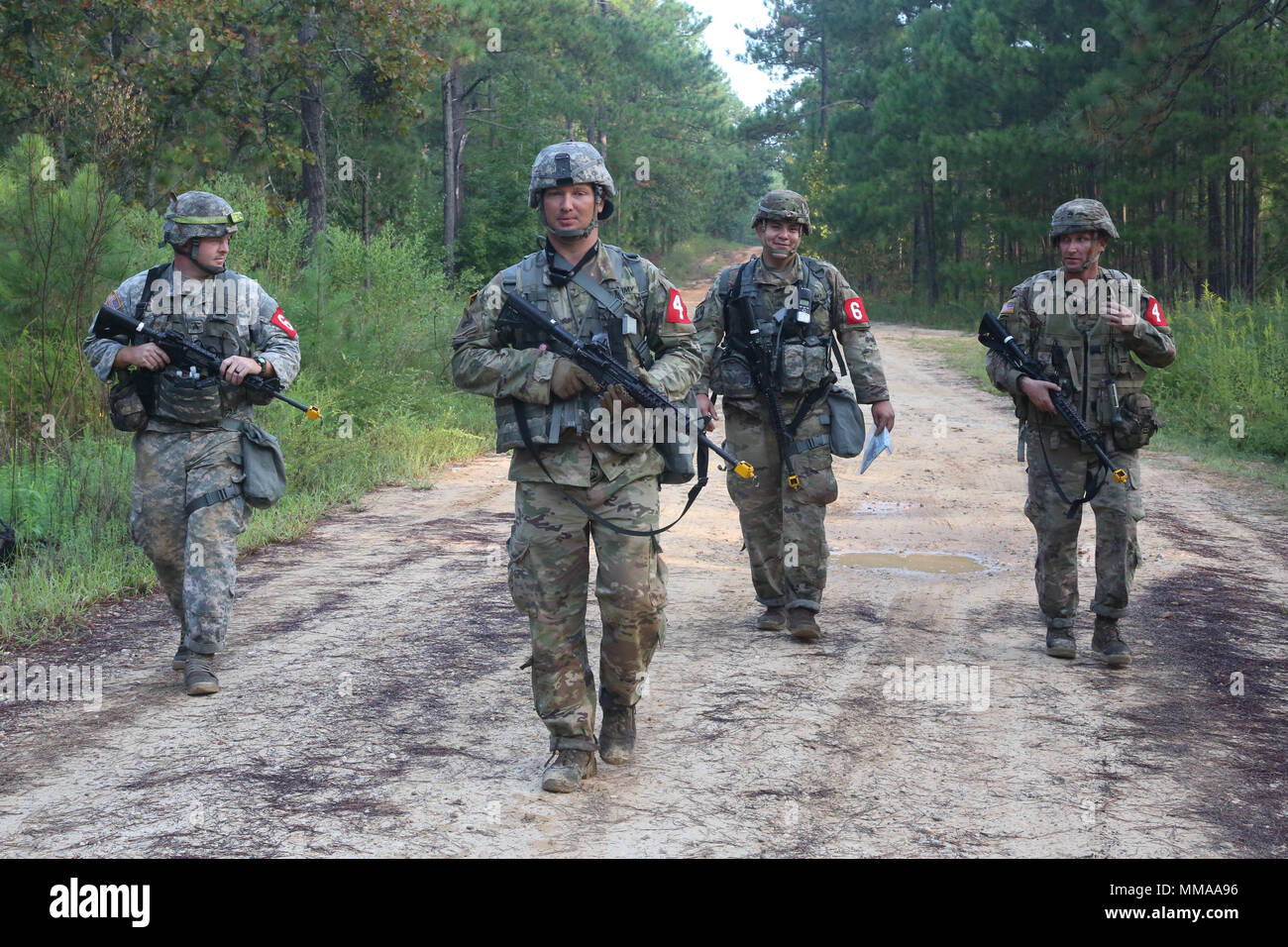 U.S. Soldiers, competing in the 2017 Best Medic Competition, walk together to the finish line after completing the Army Warrior Training at Fort Bragg, N.C., Sept. 19, 2017. The competition tested the physical and mental toughness, as well as the technical competence, of each medic to identify the team moving forward to represent the region at the next level of the competition.  (U.S. Army photo by Pfc. Meleesa Gutierrez) Stock Photo