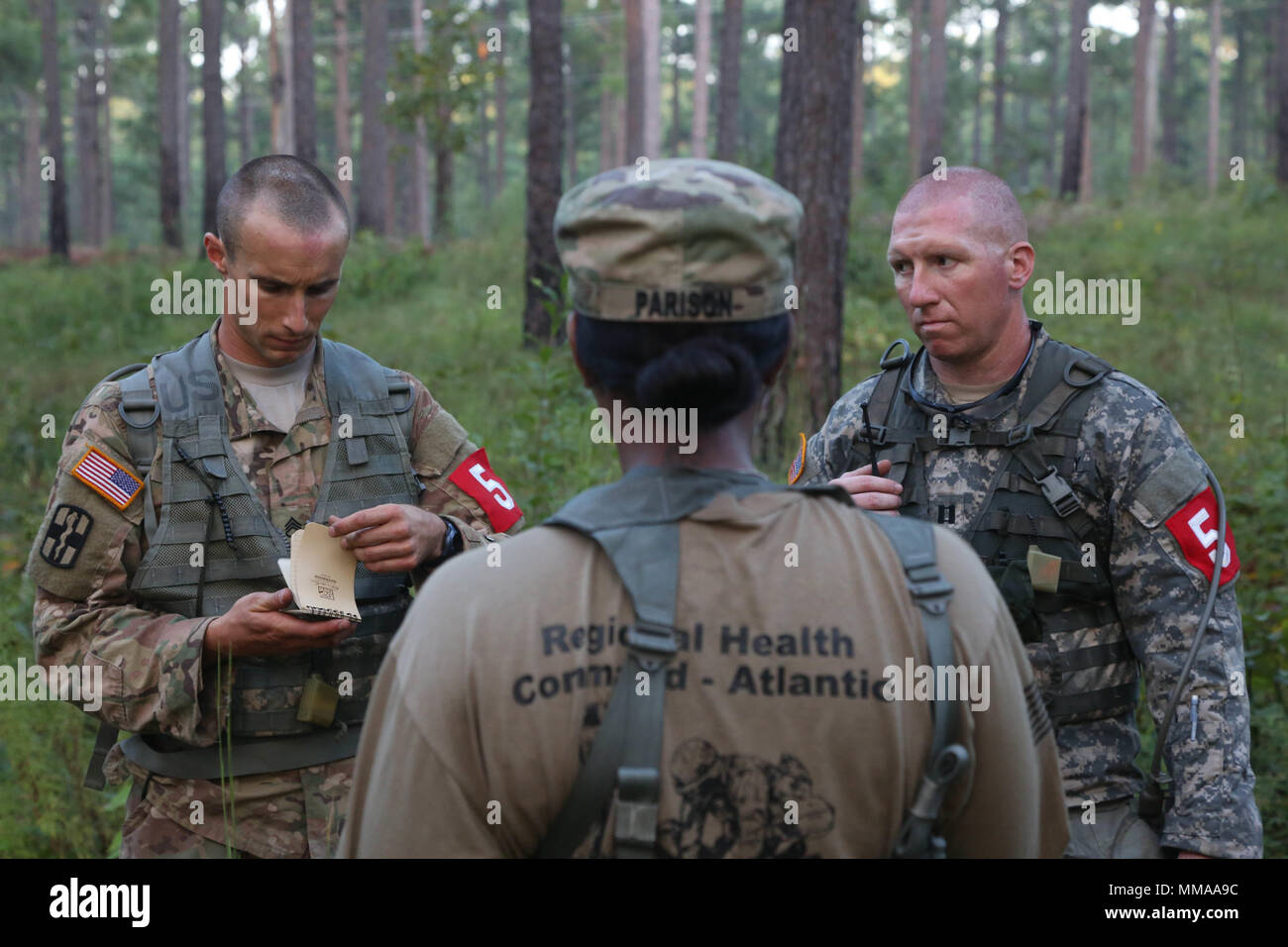 U.S. Army Staff Sgt. Joseph Karslo and Capt. Jeremy Lewis, assigned to the Public Health Command - Atlantic, listen to instructions during the 2017 Best Medic Competition at Fort Bragg, N.C., Sept. 19, 2017. The competition tested the physical and mental toughness, as well as the technical competence, of each medic to identify the team moving forward to represent the region at the next level of the competition.  (U.S. Army photo by Pfc. Meleesa Gutierrez) Stock Photo
