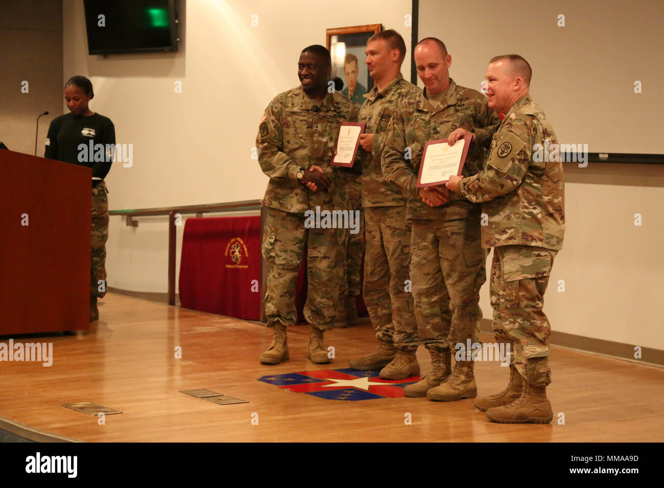 U.S. Army Sgt. 1st Class Christopher Ellis and Staff Sgt. Eric Sullivan, assigned to the Blanchfield Army Community Hospital, receive awards from Brig. Gen. R. Scott Dingle and Command Sgt. Maj. Matthew Brady during the 2017 Best Medic Competition Award Ceremony at Fort Bragg, N.C., Sept. 20, 2017. The competition tested the physical and mental toughness, as well as the technical competence, of each medic to identify the team moving forward to represent the region at the next level of the competition.  (U.S. Army photo by Pfc. Meleesa Gutierrez) Stock Photo